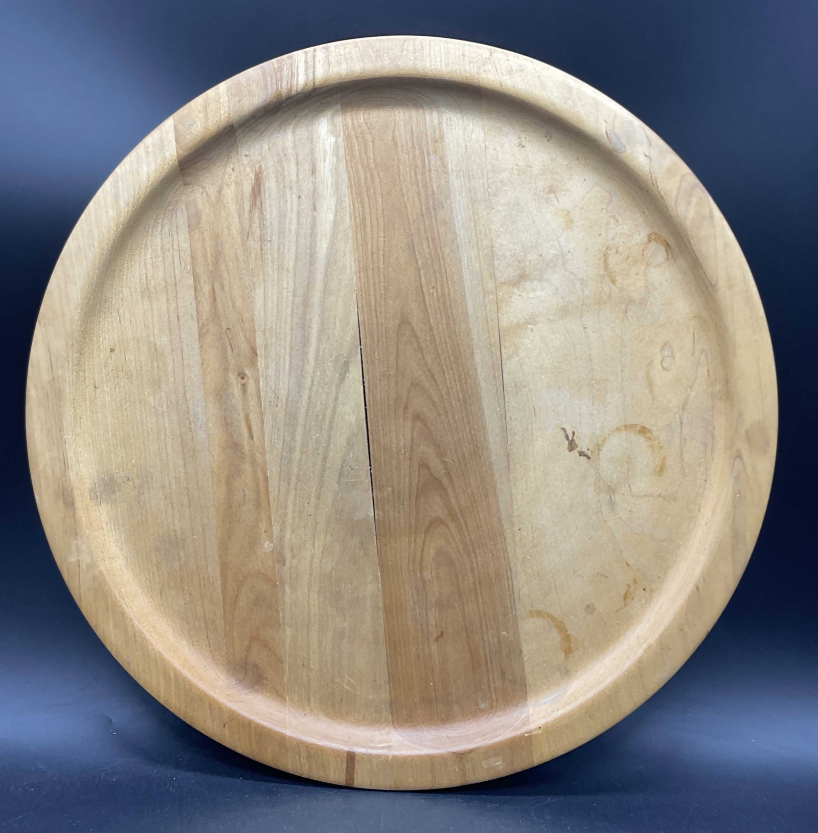 JOHN MCLEOD DESIGN USA Wooden Lazy Susan: JOHN MCLEOD DESIGN USA Wooden Lazy Susan / Swivel Serving Centerpiece. Underside signed JOHN MCLEOD DESOGN. Sticker reads MADE IN USA. Warping, cracking, and surface wear present. Measures approx. 2.5