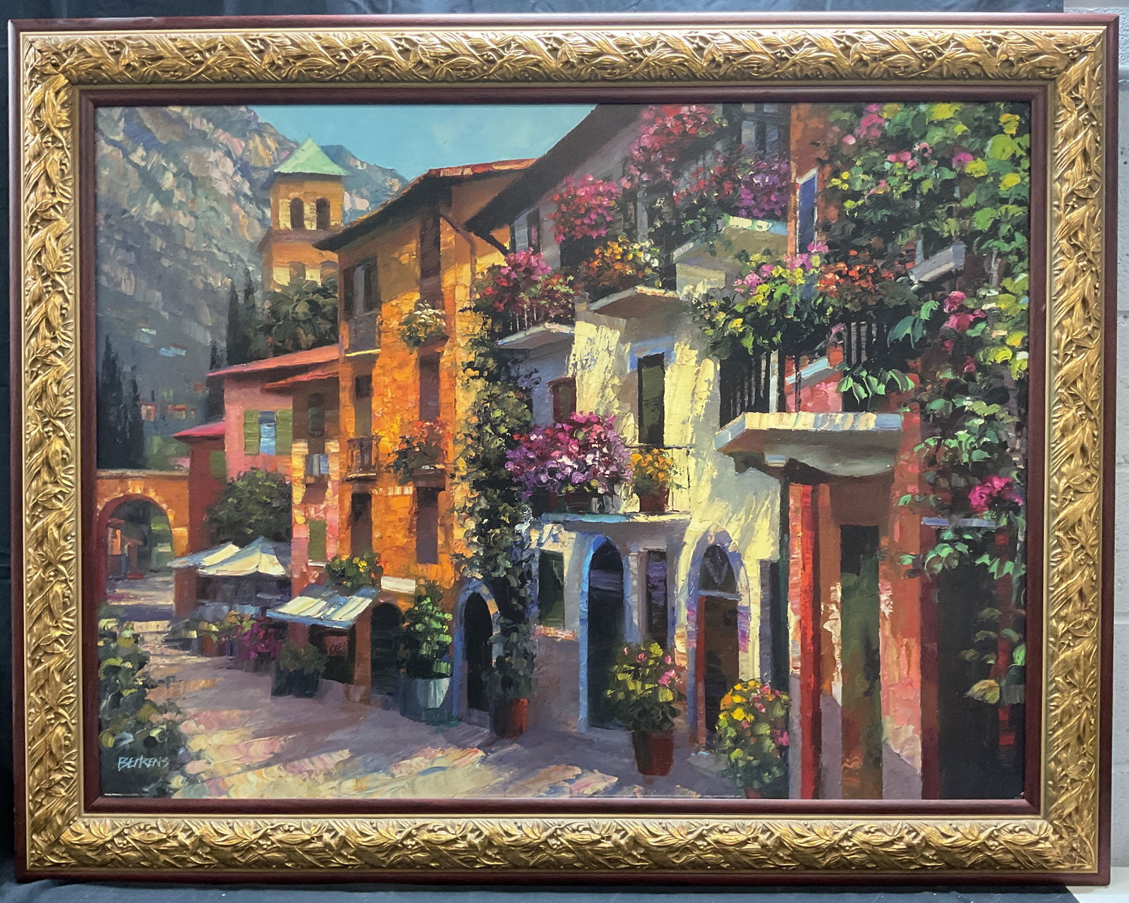 XL Framed Behrens Village Hideaway Print 4.5+Ft: Framed reproduction print on board. Village Hideaway by Howard Behrens. Village scene with building and plants. Copyright along lower edge. Signature in print at lower left. Framed in decorative wood