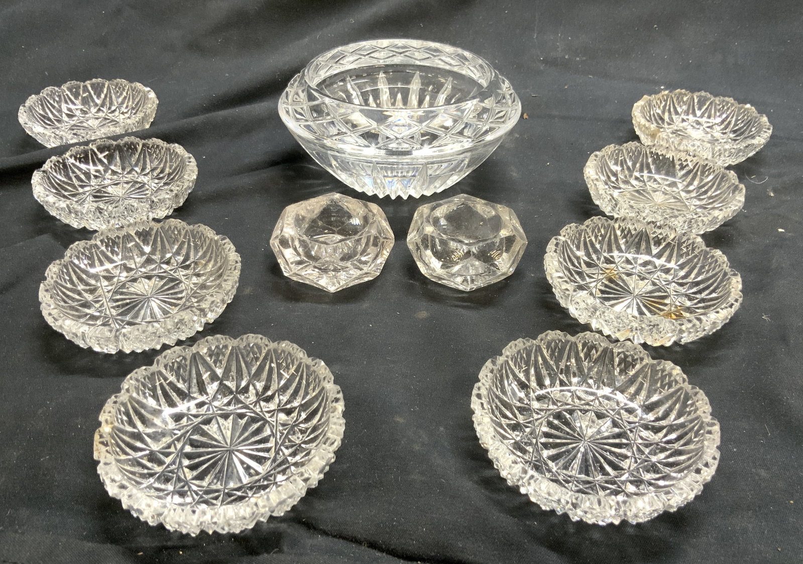 11 Crystal Vessels, Salt Cellars, Trinket Dishes: Lot includes 1 trinket dish, 2 salt cellars, & 8 toothed rim vessels. Trinket dish/bowl is crystal. Other pieces possibly crystal, possibly glass. Geometric relief detail to each. Trinket dish/bowl me