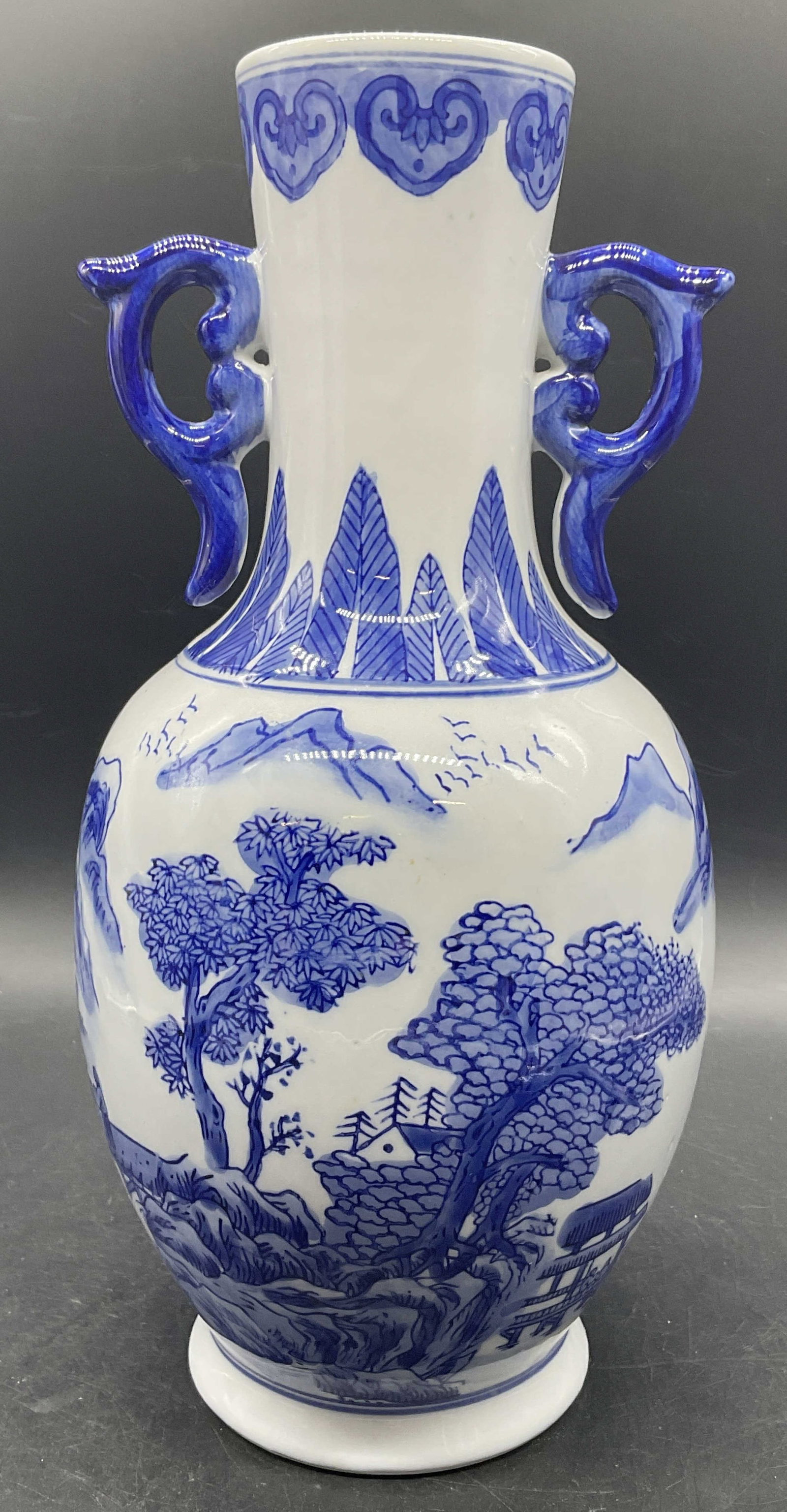 Vintage Blue & White Asian Porcelain Vase: Vintage Blue & White Asian Porcelain Vase. Decorated with figurals, birds, foliage, and geometric patterns. Measures approx. 12.25H x 5W in. Pitting, surface wear, and residue present. Underside state