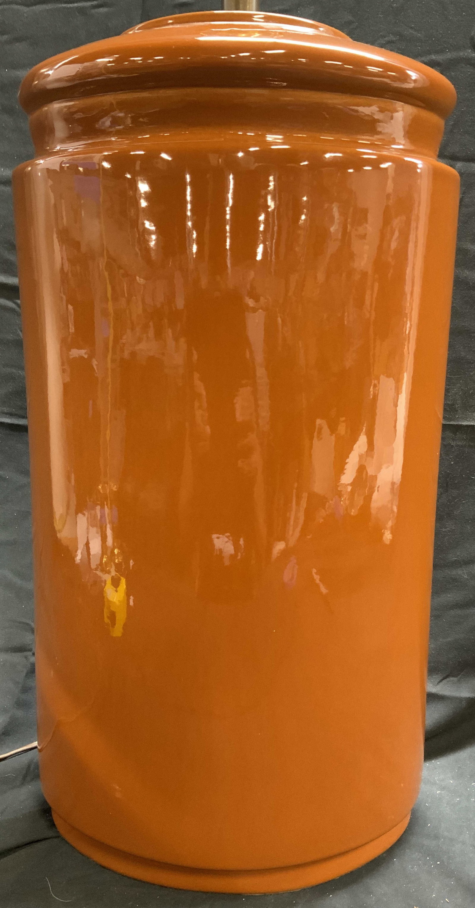 Ceramic Table Lamp W Harp & Finial Sienna: Lamp is ceramic. Piece appears to possibly be vintage. Lamp is sienna toned. Piece has gilt metal harp & finial. Underside is lined with black toned felt. Piece measures approximately 34 inches tall 1