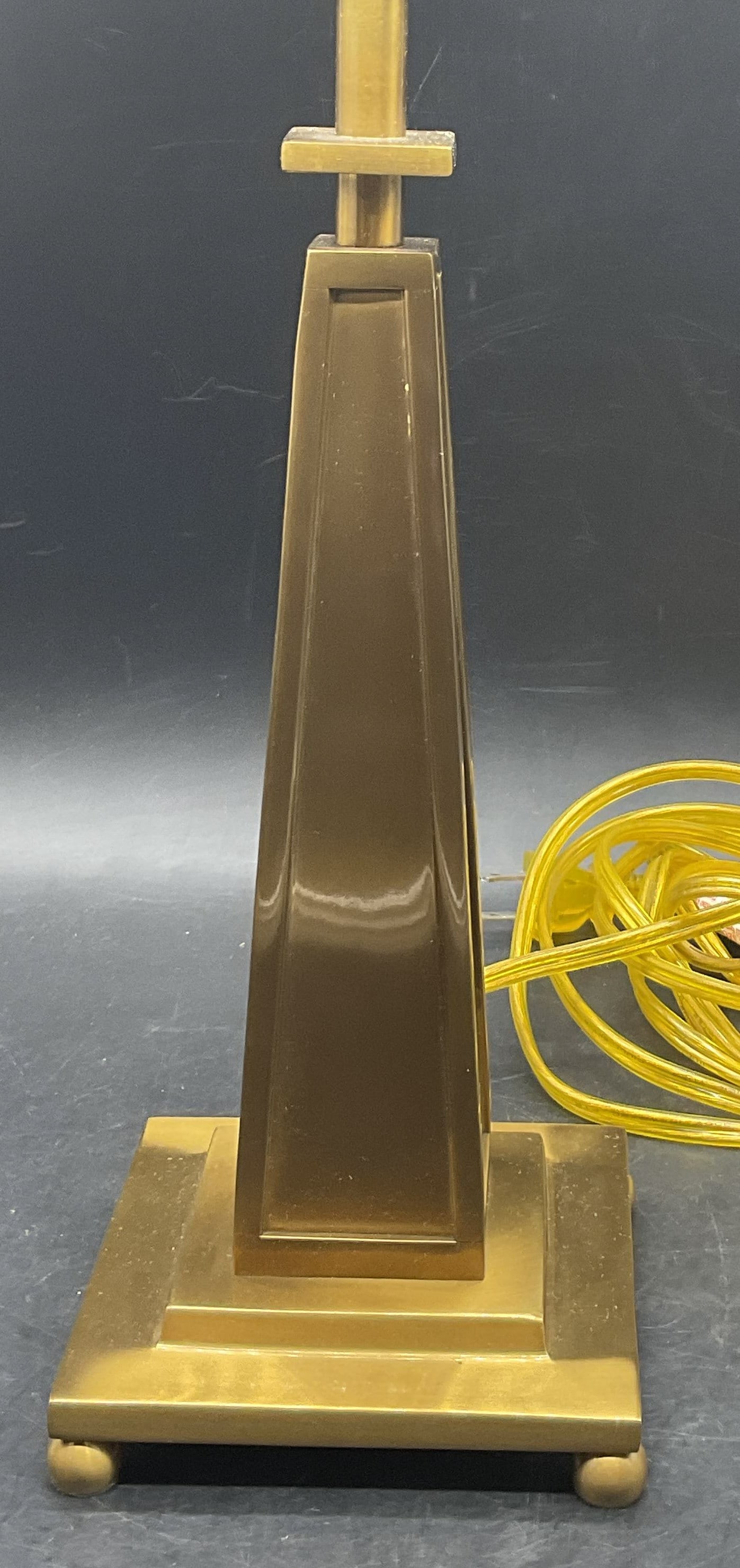 Brass Obelisk Tabletop Lamp: Brass Obelisk Tabletop Lamp. Pull chain. Measures approx. 14.5H x 4.5W in. Weighty. Corded. Not tested for function. Surface wear consistent with age, use, and exposure. Lighting, lamp, lighting fixtu