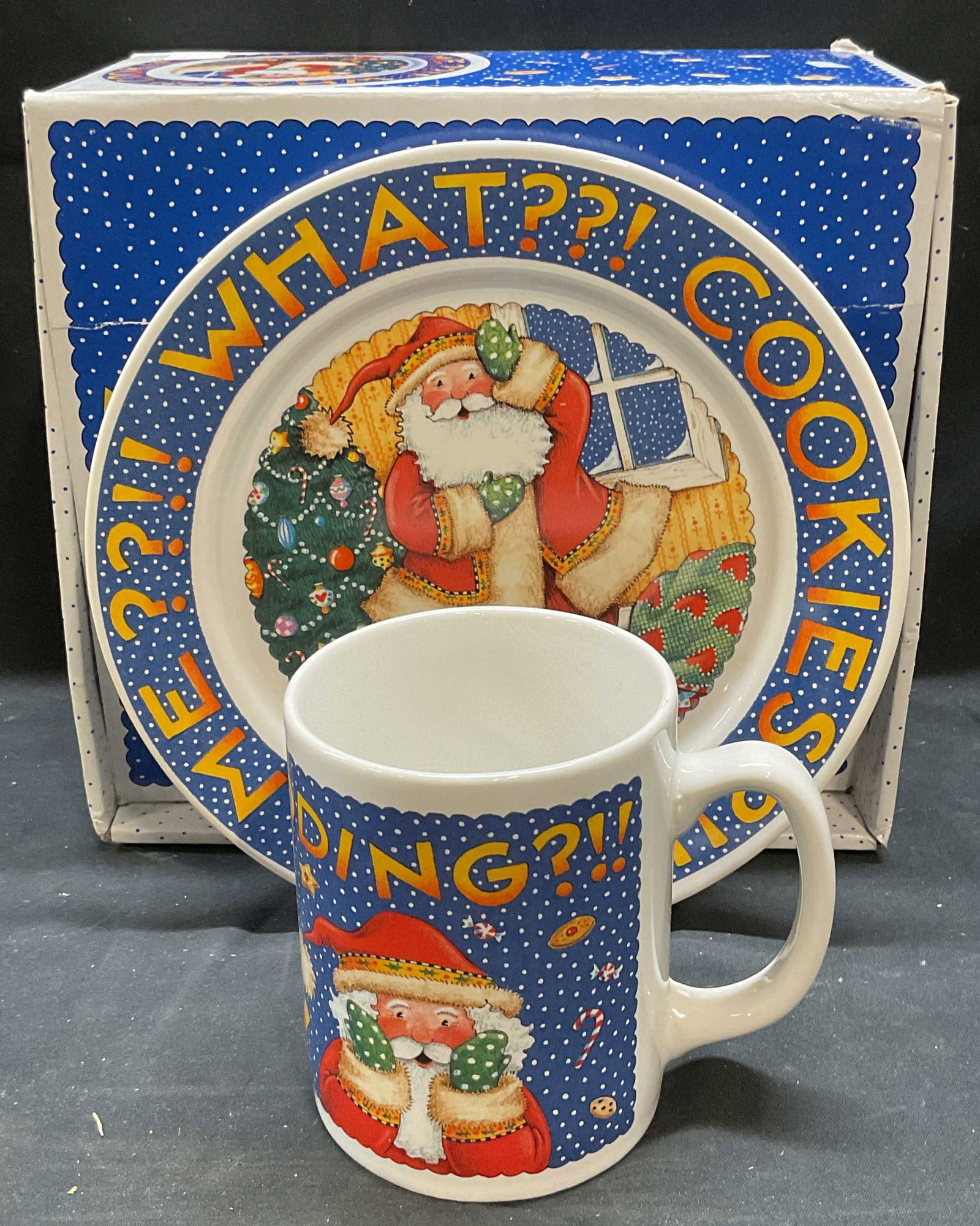 Mary Engelbreit Porc Santa Milk & Cookies Set: Mary Engelbreit porcelain plate and mug set. Santas Milk and Cookies. Christmas pattern. Includes box. Plate measures approx 7.75 inches. Mug approx 3 x 4 inches. Some wear to each consistent with exp