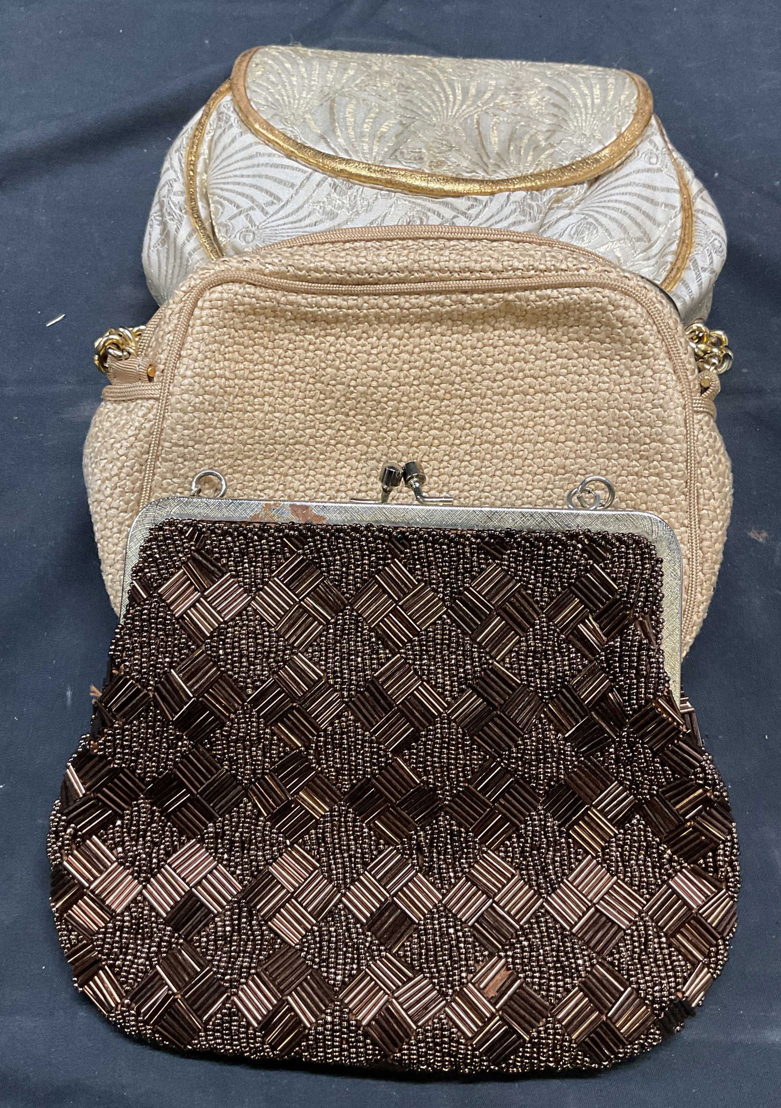 Lot 3 Vintage DeVecchi Italy, Gumps, Handbags: DeVecchi tan woven handbag. Made in Italy. Gumps San Francisco cream damask handbag. Metallic brown beaded handbag. Largest approx 6.5 x 1.5 x 6 inches. All pieces have wear including pulling, blemish