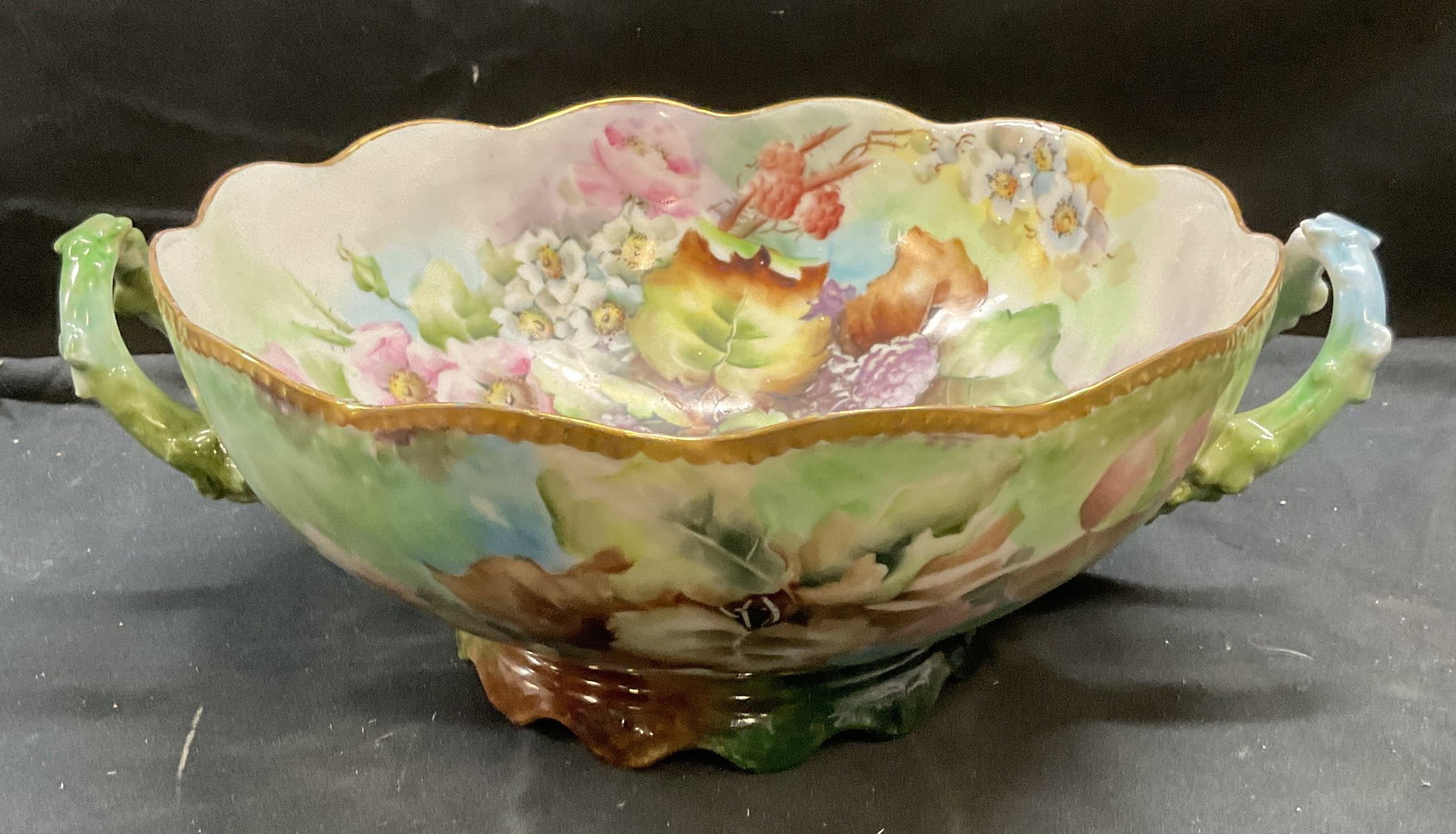 T & V Limoges Century Porcelain Bowl, France: T & V Limoges Century porcelain bowl with handles. Hand painted with floral design. Made in France. Signed on underside. Measures approx 10 x 4.5 inches. Some wear including scratching observed. T and
