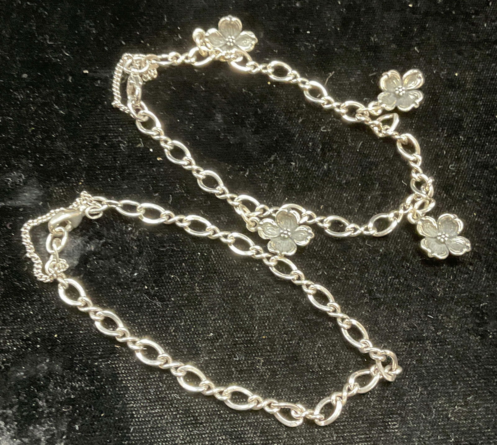 Lot 2 Sterling Silver Flower Bracelet, Chain: Lot of 2 sterling silver chain bracelets, one bracket with flower pendants. Marked sterling on clasps. Drop length approx 3.75 inches each. Total weight of both 19.8 grams. Both pieces have wear inclu