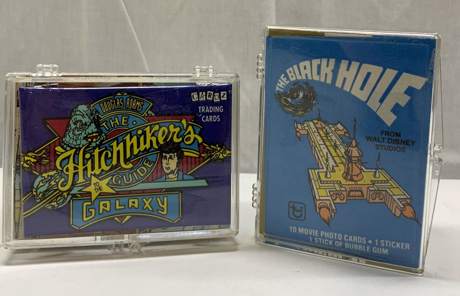 Lot 1994 CARDZ & 1979 WALT DISNEY Trading Cards: Group Lot 1994 CARDZ & 1979 WALT DISNEY TRADING CARDS A group lot of 1994 The Hitchhikers Guide to the galaxy & The black Hole trading cards. Plastic container is holding cards inside. Trading cards h