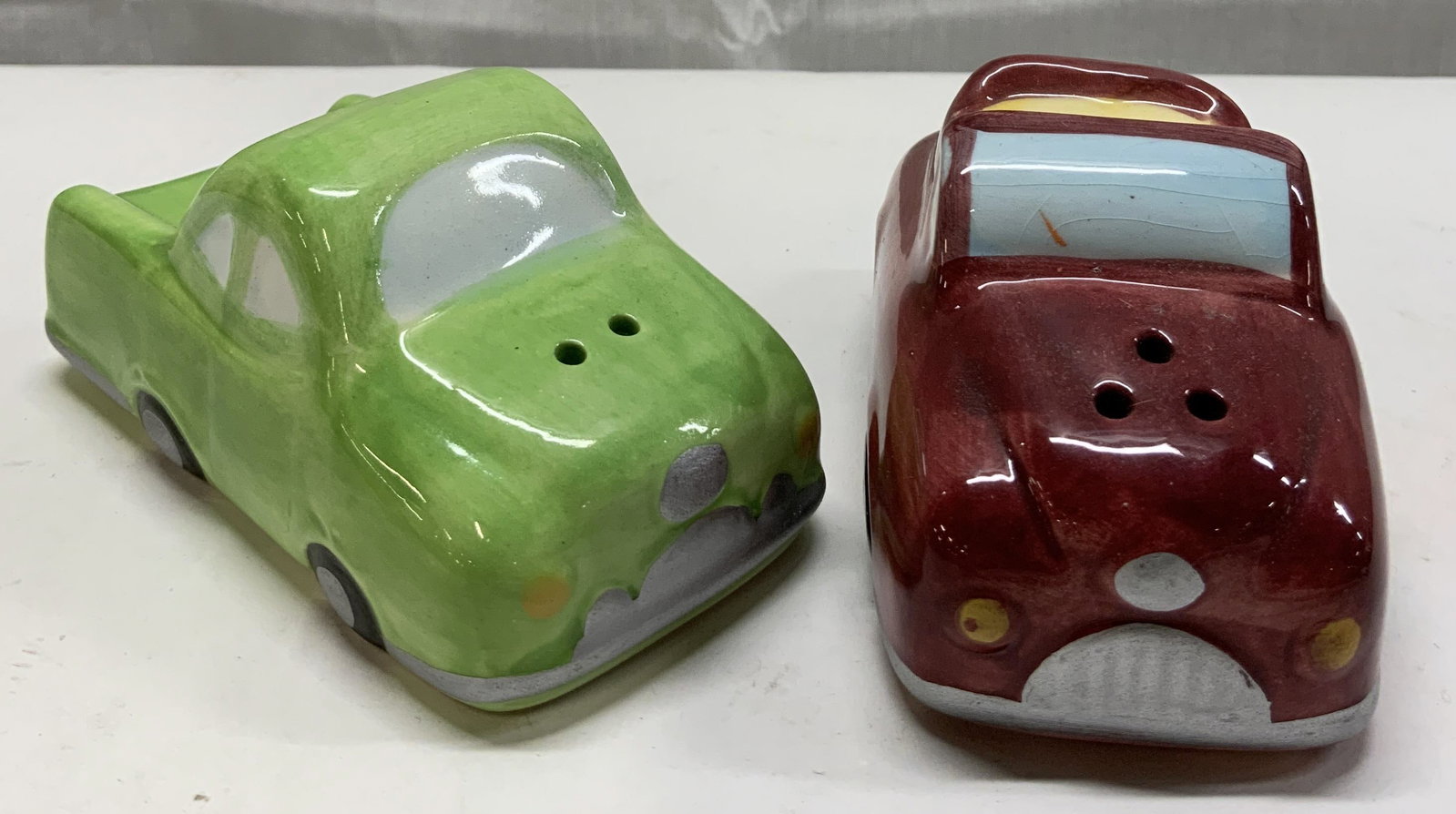 WCL Ceramic Car & Truck Salt & Pepper Shakers: WCL Ceramic Car & Truck Salt & Pepper Shakers Pair of salt & pepper shakers, that depict a green truck & a red car. Underside is signed & marked. Surface wear consistent to age, use & exposure. Measur