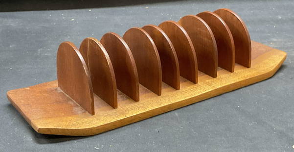 MCM Anri Form Teak Wood Toast Rack: Vintage mid century modern ANRI Form teak wood toast rack. Signed on underside. Measures approx 10.75 x 4.25 x 2.25 inches. Some wear including scratching. Anti form, anti form toast rack, teak toast