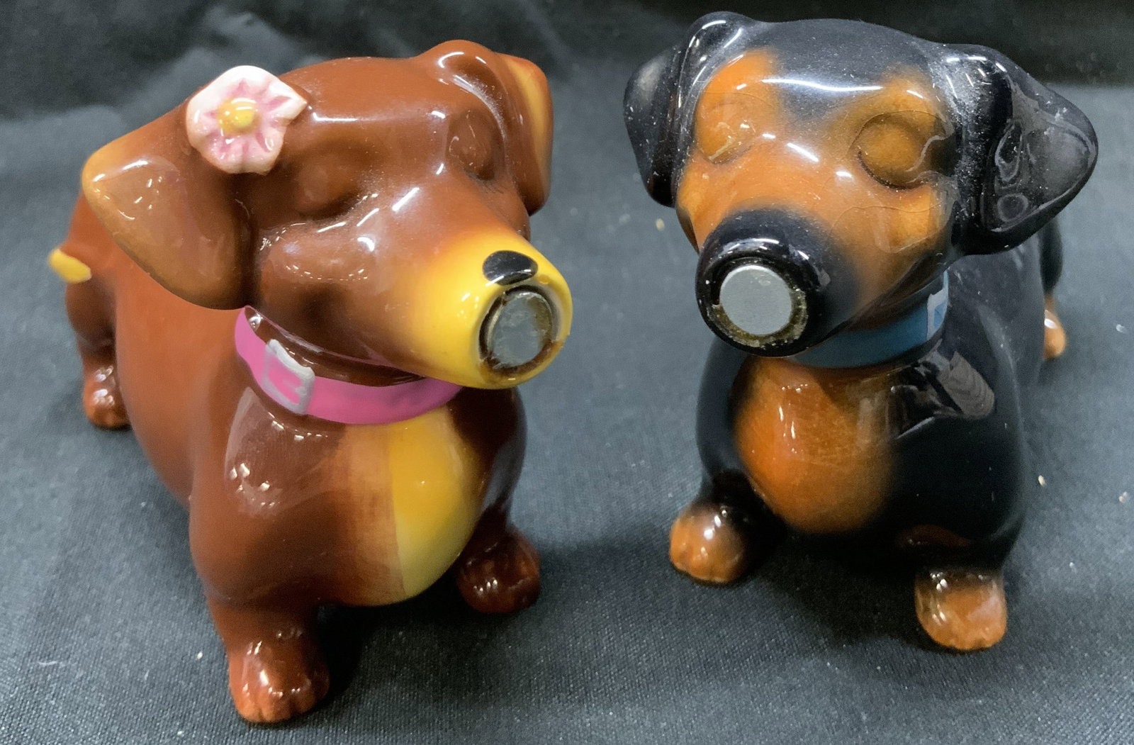 Dachshund Weiner Dog Salt & Pepper Shakers: Dachshund Weiner Dog Salt & Pepper Shakers Porcelain salt & pepper shaker that depict a brown & black dachshund Weiner dog. Black dog is wearing a blue collar, and brown dog is wearing a pink collar w