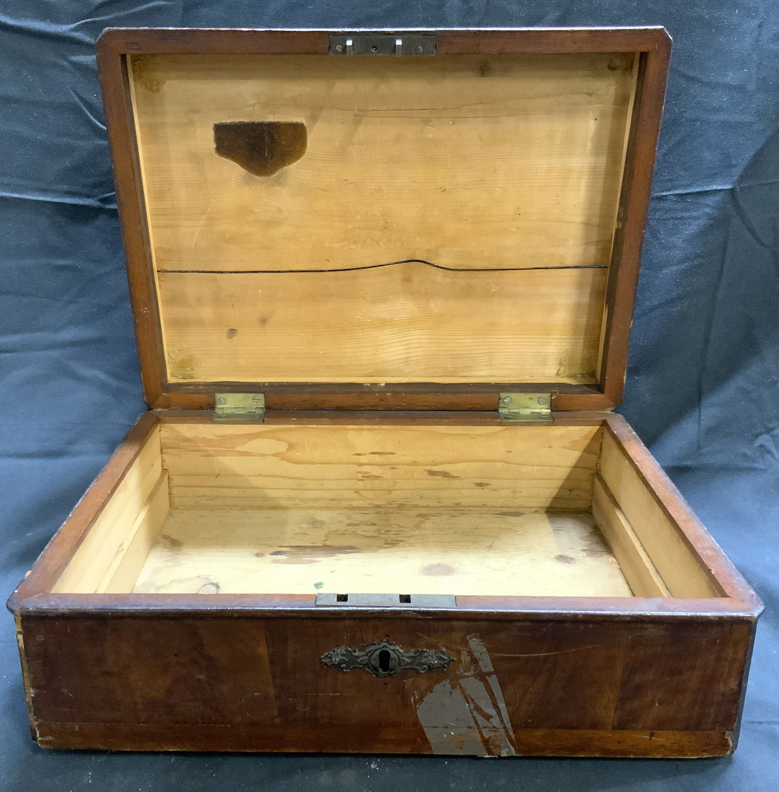 Antique Wooden Writing Box W Lid: Writing box is appears to be antique possibly vintage. Piece is brown toned and wooden. Writing box has hinged lid. Piece has gilt metal escutcheon. Writing box measures approximately 14.5 inches long