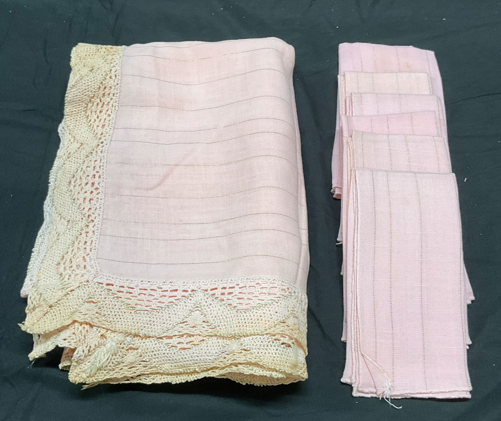 Set 7 Pink Striped Tablecloth & Napkins: Set of 7 table linens. Pink and metallic gold striped tablecloth with lace trim. Feels like cotton, possibly blend. 6 matching napkins. Tablecloth measures approx 44 x 64 inches. Napkins measure appro