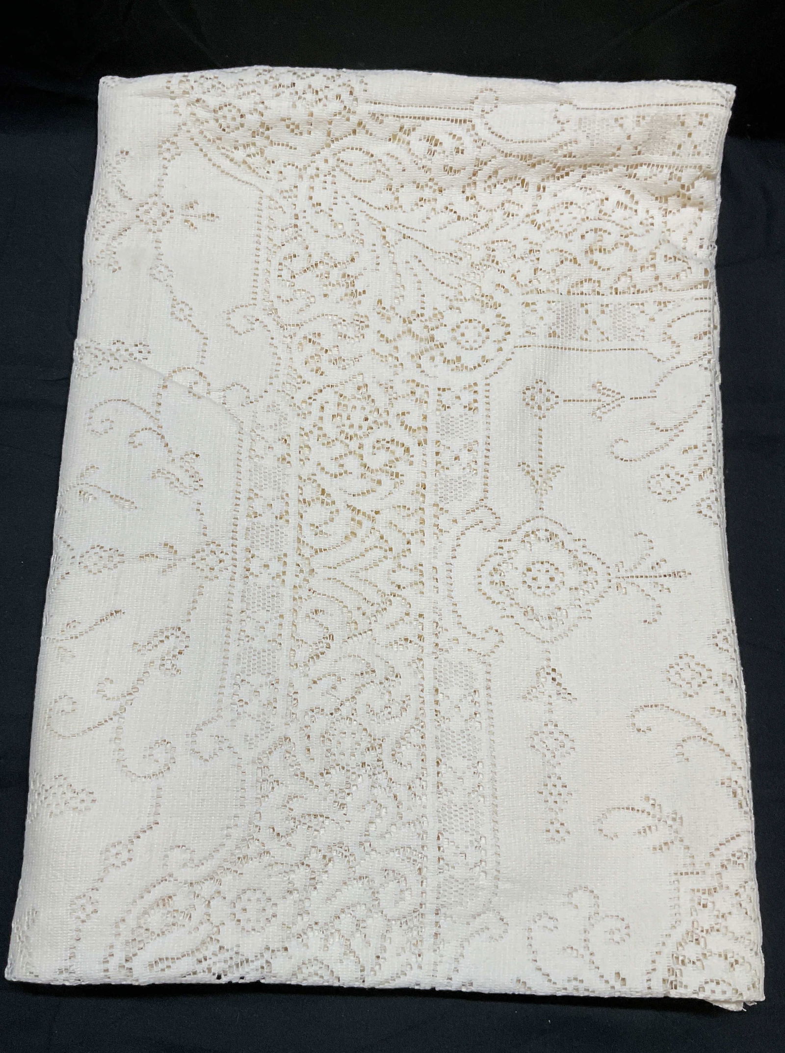 Vintage Cream Lace Tablecloth: Vintage cream toned lace tablecloth. Material feels like cotton, possibly blend or synthetic material. Measures approx 76 x 54 inches. Some wear including blemishes, pulls, and tears. Tablecloth, lace