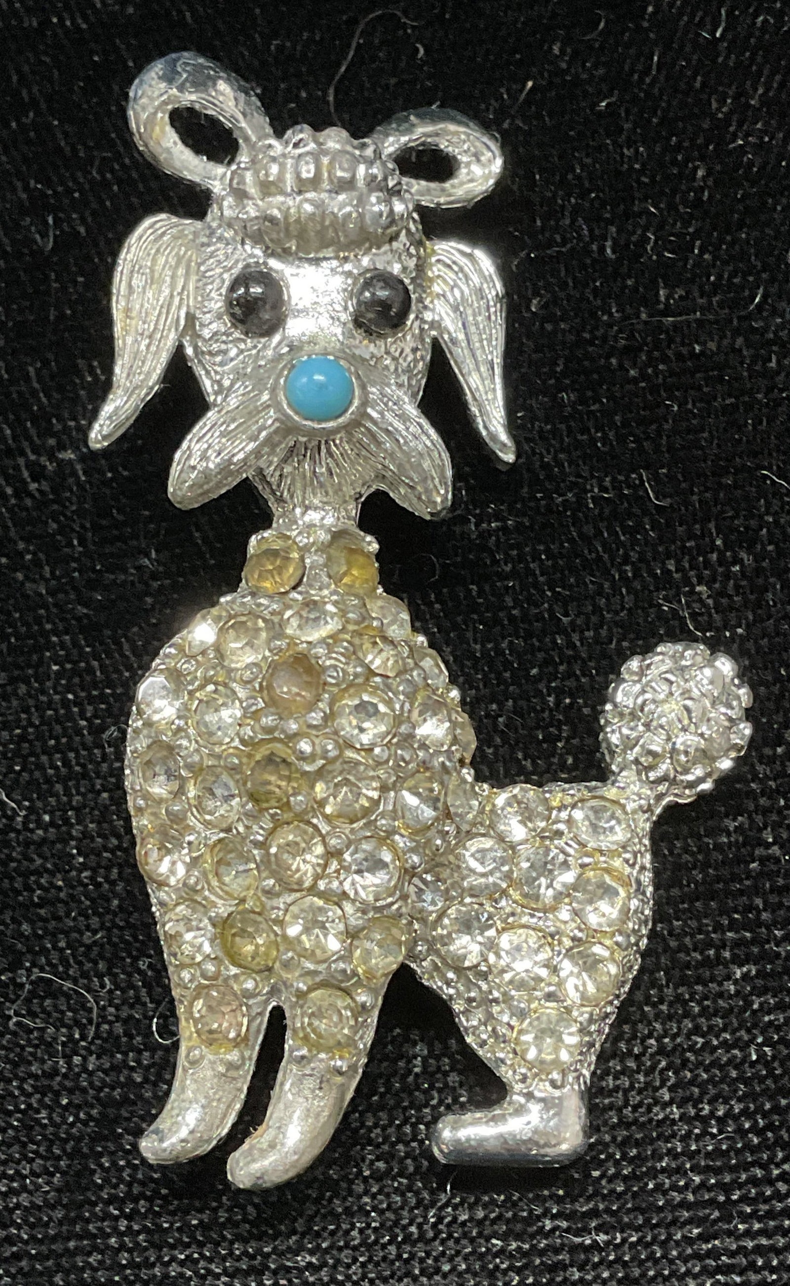 Vintage Silver Tone Crystal Poodle Dog Brooch: Vintage silver tone crystal poodle dog motif brooch. Hinge pin on underside. Measures approx 2 x 1 1/8 inches. Some wear including scratching and discoloration observed. Jewelry, estate jewelry, costu