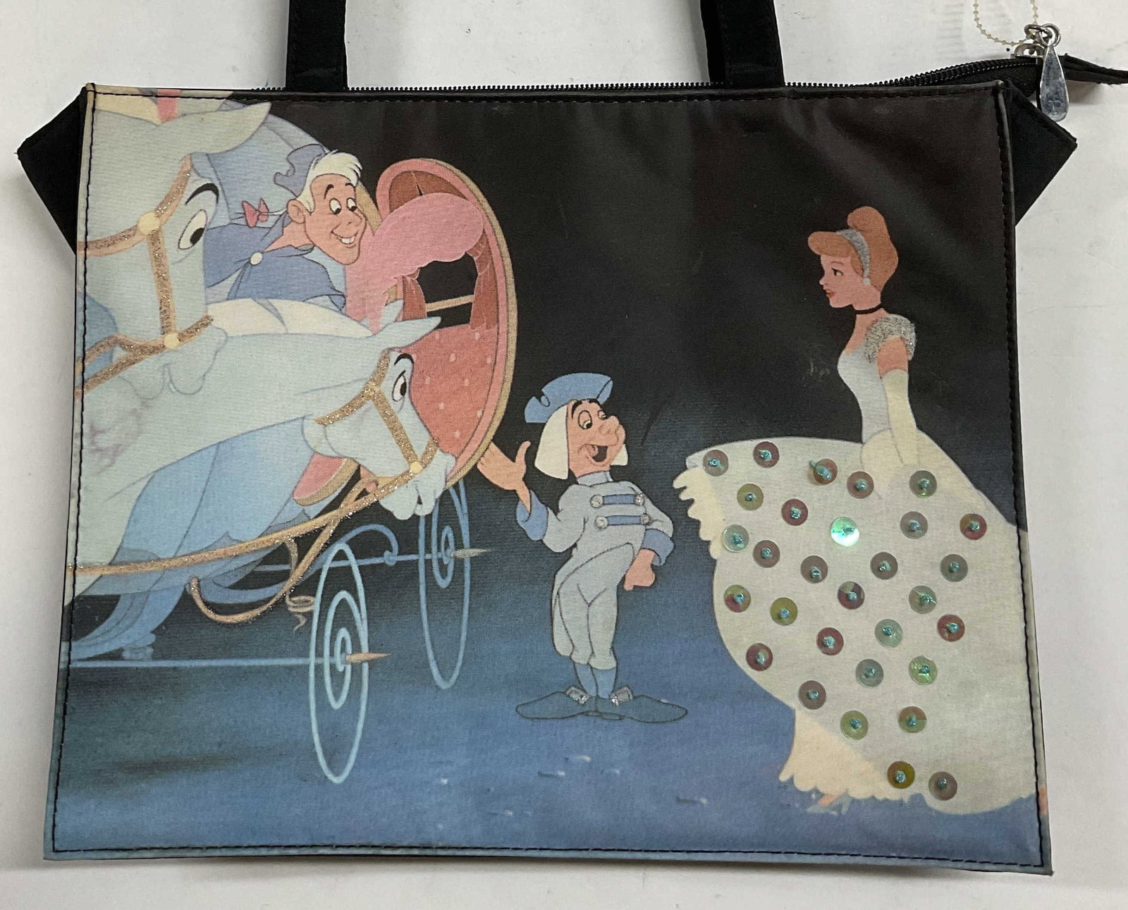 Walt Disney Cinderella Blue Handbag: Walt Disney Cinderella print handbag in blue and black with sequin detail. Interior pockets. Synthetic material. Measures approx 11.5 x 3.75 x 9 inches. Some wear including blemishes observed. Cindere