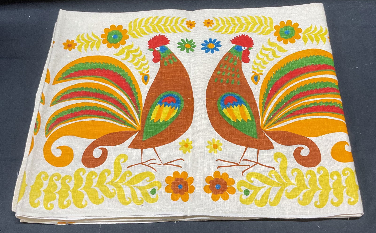 Vintage Rooster Print Linen Tablecloth: Vintage linen tablecloth with graphic rooster print. Multicolor on white. Measures approx 68 x 50 inches. Some wear including blemishes and small holes observed. Additional wear may be present. Tablec