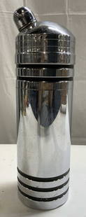 GAEITY Art Deco Chrome Cocktail Shaker: Cocktail shaker appears to be GAEITY. Piece is silver with black toned horizontal stripes. Appears to be chrome. Cocktail shaker includes lid. Piece measures approximately 12.25 inches tall 3.75 inche