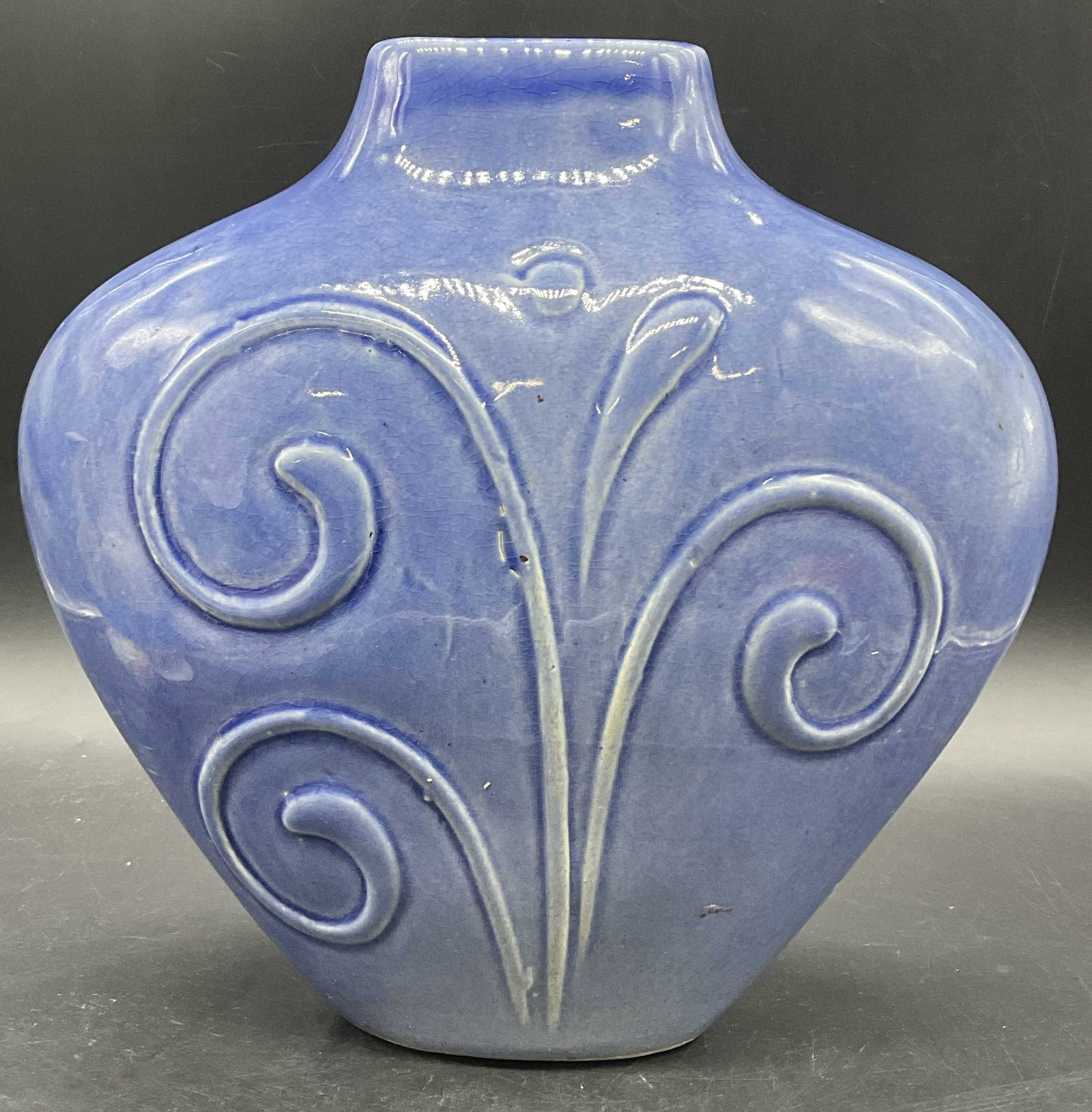 Vintage Blue Glazed Pottery Vase: A vintage blue tone glazed pottery vase with a raised scroll design to the obverse and reverse. Measures approx. 10.25H x 10W in. Crazing, pitting, and surface wear present. home decor, home accents, 