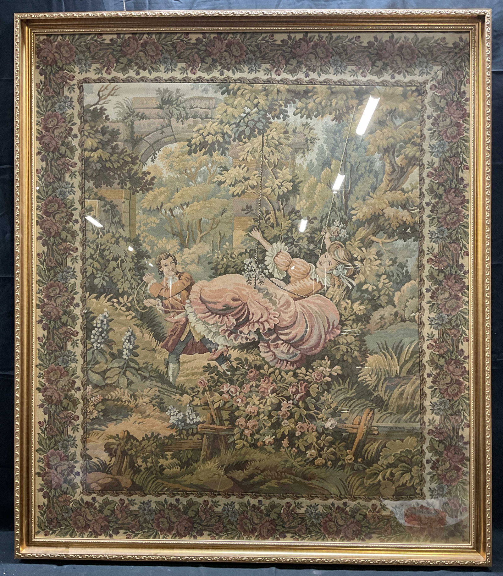 Framed Fragonard The Swing Needlepoint Tapestry: Framed needlepoint tapestry. Based on The Swing by Jean Honore Fragonard. Man pushing a woman on a swing in a garden. Decorative gilt frame. Not examined out of frame. Frame measures approx 49 x 42 in