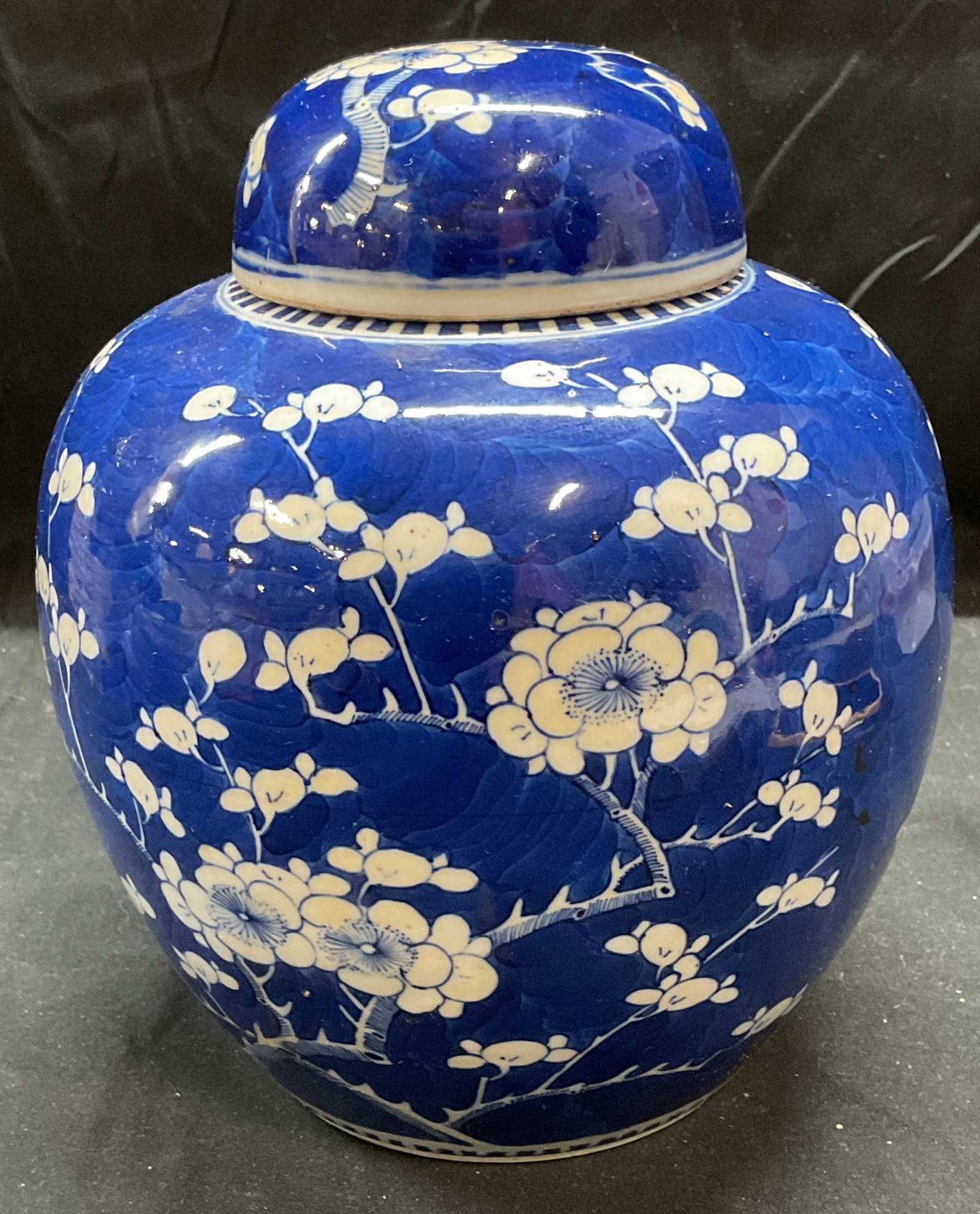 Signed Chinese Blue & White Porcelain Ginger Jar: Signed vintage Chinese porcelain ginger jar. Hand painted blue and white. Floral design. Signed on underside. Measures approx 6.5 x 8.25 inches. Some wear including scratching and hairline crack obser