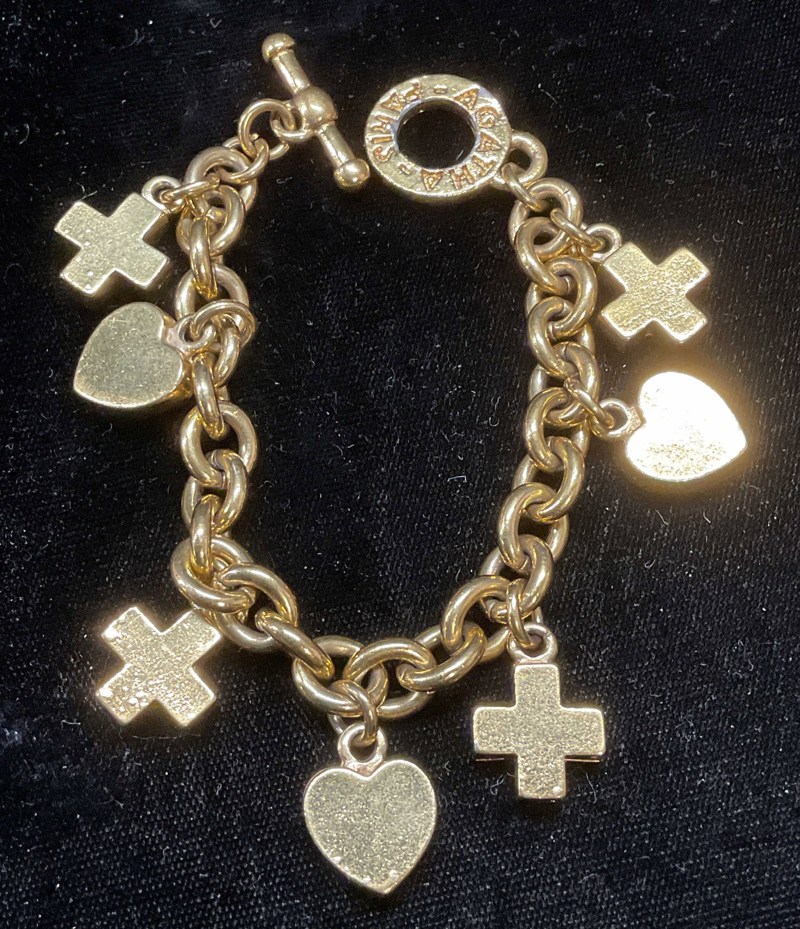 Vtg Agatha Paris Gold Tone Charm Bracelet: Vintage Agatha Paris gold tone charm bracelet. Heart and x shaped charms. Signed on clasp. Measures approx 7 inches long. Piece has weight. Some scratching observed. Jewelry, estate jewelry, costume j
