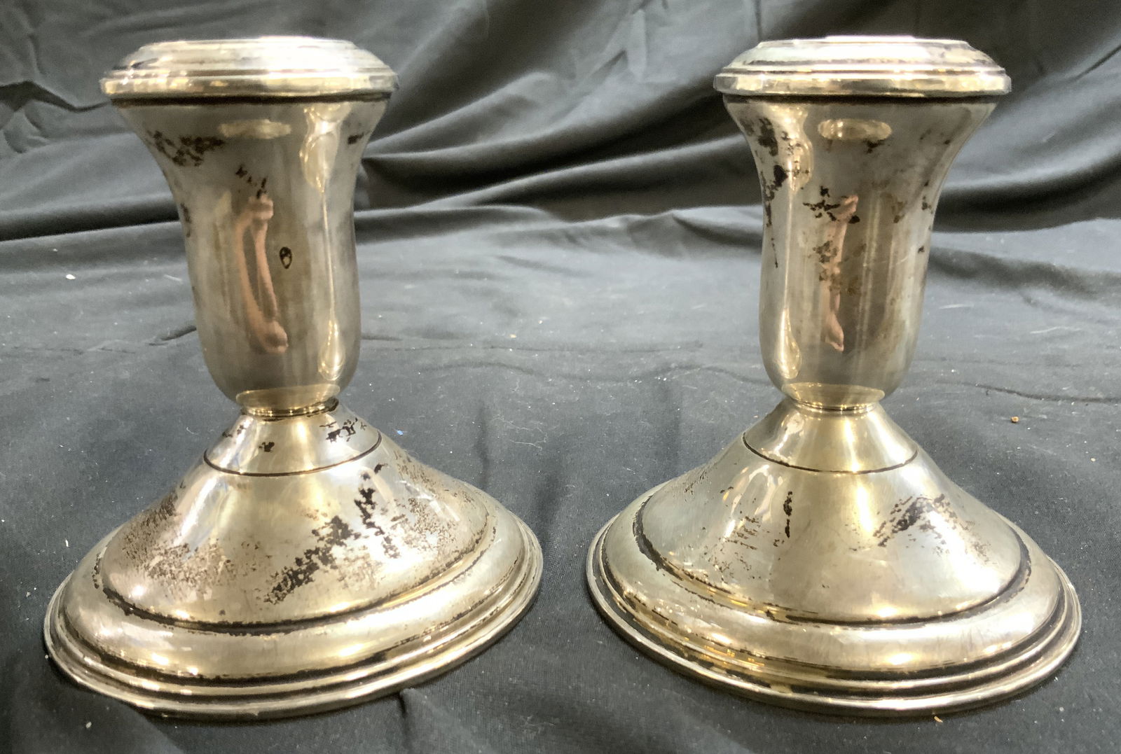 AMG Pair Vntg Sterling Silver Candlesticks: Undersides of candlesticks are inscribed AMG STERLING WEIGHTED. Lot includes 2 Candlesticks, each are sterling weights. Candlesticks each have circular form bases. Candlesticks appear to be vintage. E