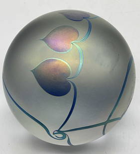 1987 Robert Eickholt Vine Motif Glass Paperweight: 1987 Robert Eickholt Heart Vine Motif Art Glass Paperweight. Iridescent hue to the glass. Underside signed Eickholt 1987. Measures approx. 3.5H x 3.25W in. Sticker residue and surface wear present. ho