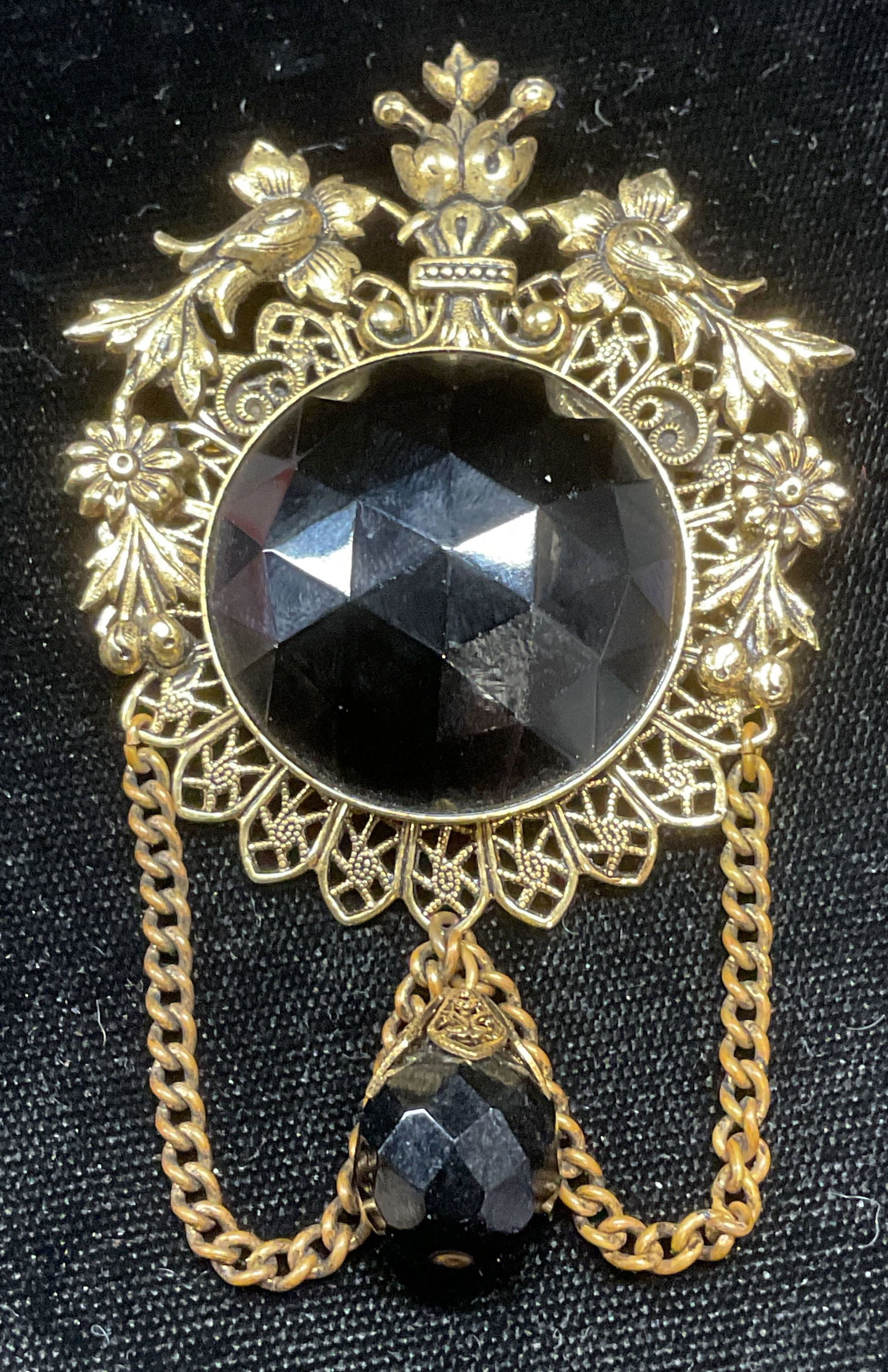 Vintage Gold Tone Black Crystal Brooch: Vintage gold tone floral scroll brooch with black crystal decoration. Measures approx 3 x 2 inches. Some scratching observed. Jewelry, estate jewelry, costume jewelry, cocktail jewelry, fashion jewelr