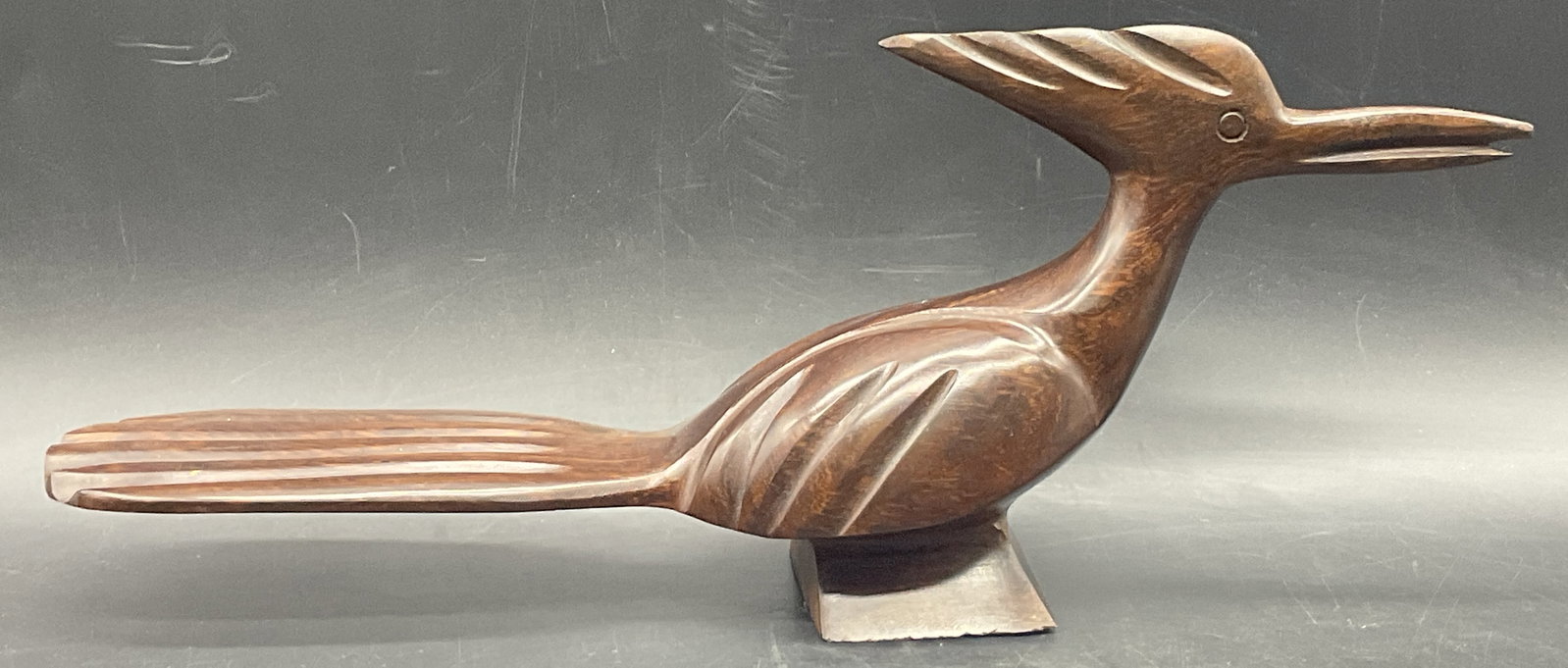 1996 Artist Signed Carved Wood Roadrunner Figural: 1996 Artist Signed Carved Wood Roadrunner Figural. The underside is signed by the artist, illegible. Underside dated 1996. Measures approx. 5.25H x 13W in. Measured at widest point. Surface wear and c