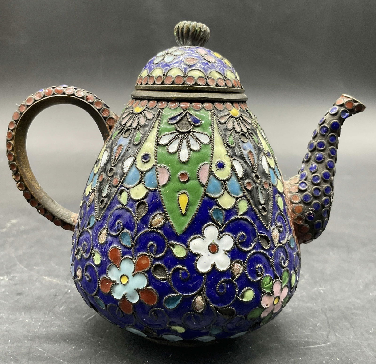 Vintage Multicolored Cloisonne Teapot Trinket, Lid: Vintage Multicolored Cloisonne Teapot Trinket. Lidded. Measures approx. 3.5H x 4W in. Measured at widest point. The finial to the lid is loose. Surface wear consistent with age, use, and exposure. hom