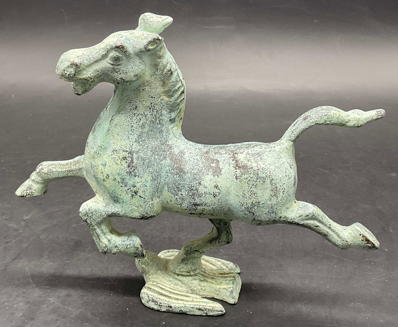 Vintage Flying Horse of Gansu on Swallow Figural: Vintage Flying Horse of Gansu on Swallow, also known as the Bronze Running Horse, replica figural. Crafted from metal, decorated with patina. Measures approx. 5.75H x 7W in. Surface wear consistent wi