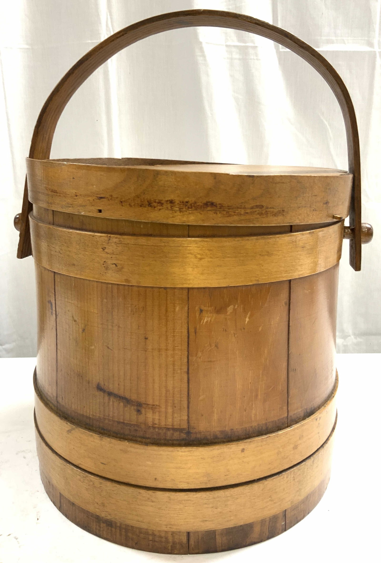 Antique 1900s French Handled Wood Bucket W Lid: Bucket is antique and wooden, circa early 1900?s. Piece has dark tan tones. Bucket has arch form handle and includes lid. Piece measures approximately 10 inches tall 9.25 inches wide. Bucket, wooden b