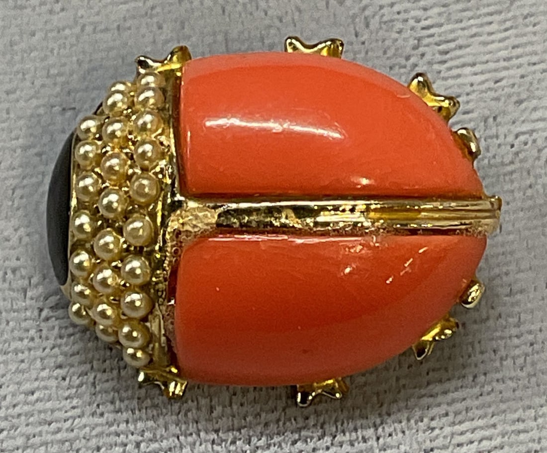 Vtg Gold Tn Lucite Faux Pearl Ladybug Brooch: Vintage gold tone ladybug motif brooch with pink lucite, faux pearl, and black enamel. Measures approx 7/8 x .75 inches. Some wear including scratching observed. Jewelry, estate jewelry, costume jewel