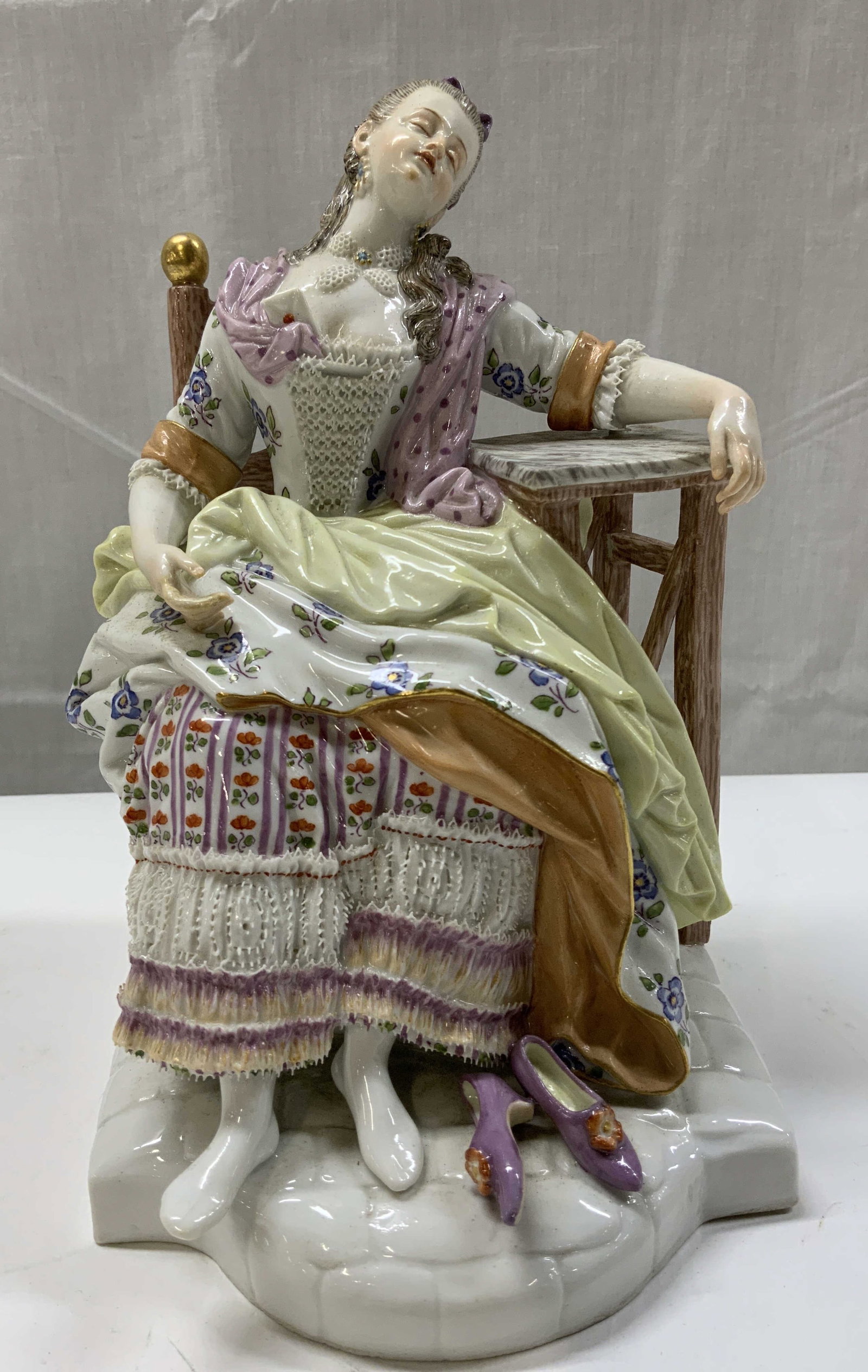 Vntg Meissen Porcelain Sleeping Girl Figural: Vntg Meissen Porcelain Sleeping Girl Figural Meissen porcelain figural depicting a sleeping girl on a porcelain wooden chair. Figural has her left arm resting on a table. She is wearing a floral dress