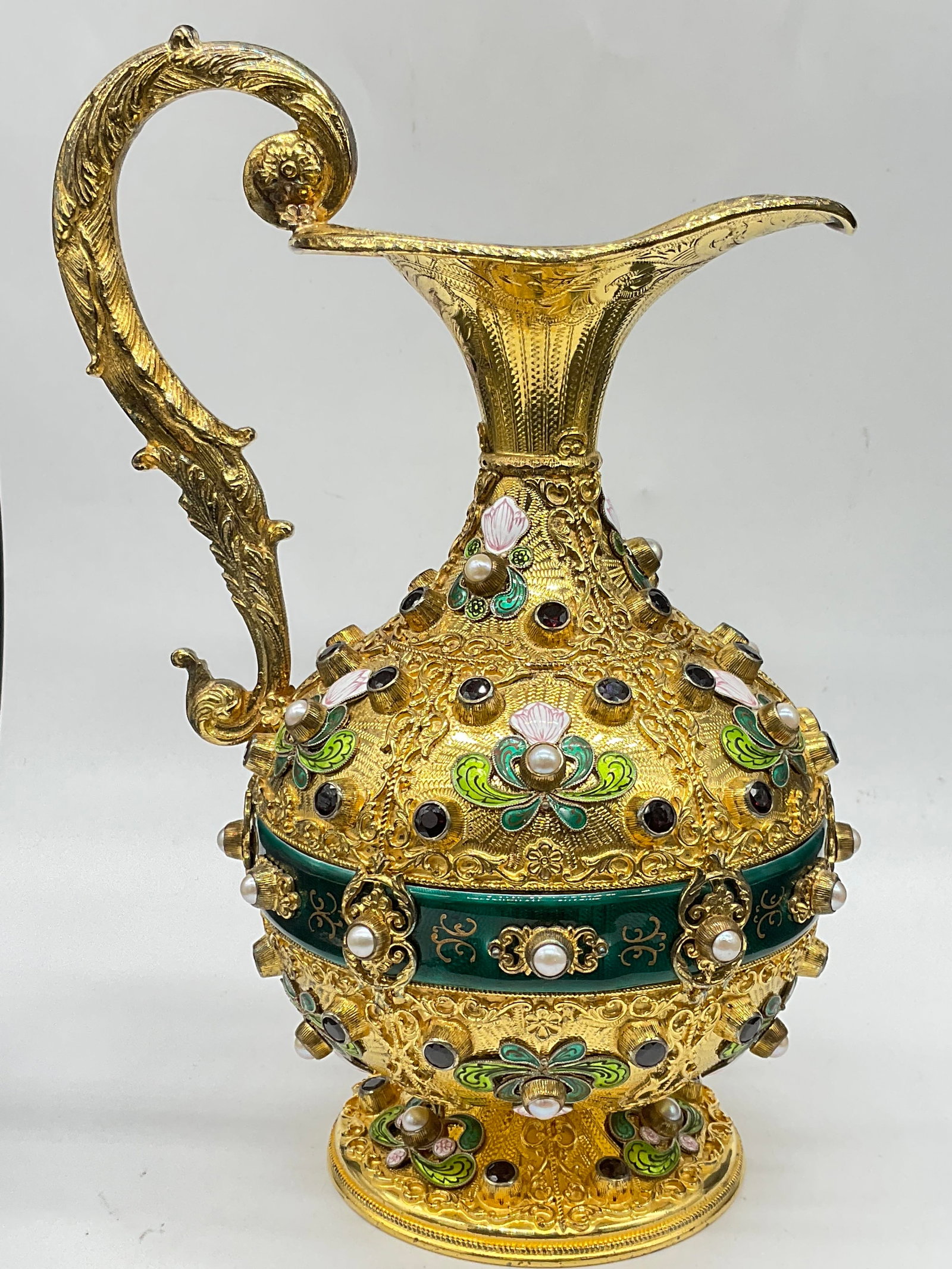 Pearl & Semiprecious Stn Gilt Sterling Enamel Ewer: Pearl & Semi Precious Red Stone Gilt Sterling Ewer. The faceted semiprecious red stones appear to be garnets. The floral and foliage enamelwork is primarily green, pink, and white hues. The guilloche 