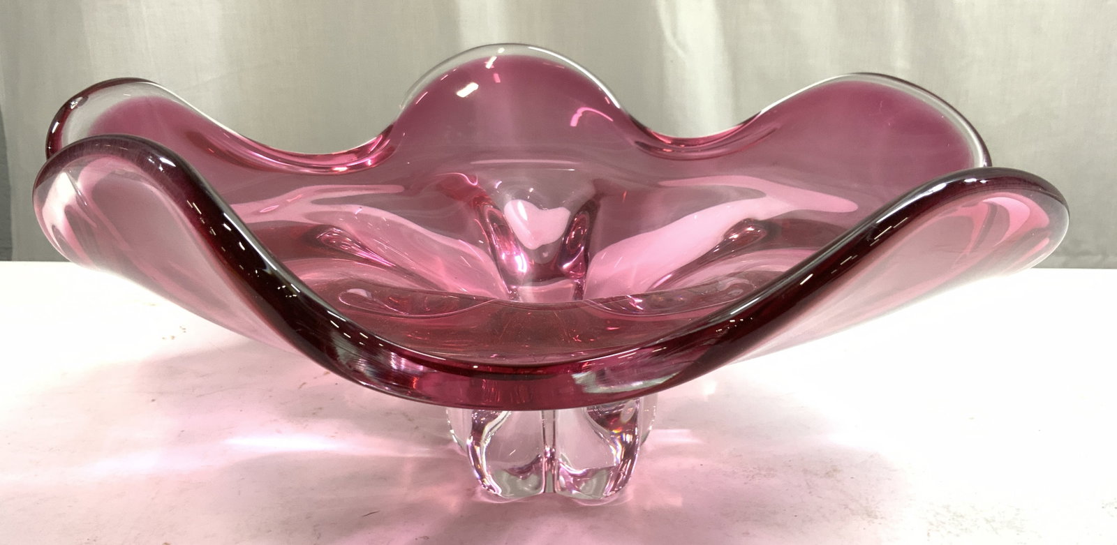 Vntg Murano Cranberry Glass Centerpiece Bowl: Bowl is cranberry glass. Piece appears to be MURANO (No apparent markings). Piece is possibly hand blown. Bowl has floral form. Piece measures approximately 14.5 inches wide 6.25 inches tall. Bowl, ce