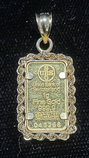 Union Bank Switzerland .999 Gold Pendant: Union Bank of Switzerland fine .999 gold bar pendant with 14k gold frame. Marked .999 on bar and 14k on bail. Measures approx.75 x .5 inches. Total weight 1.3 dwt. Some wear including scratching obser