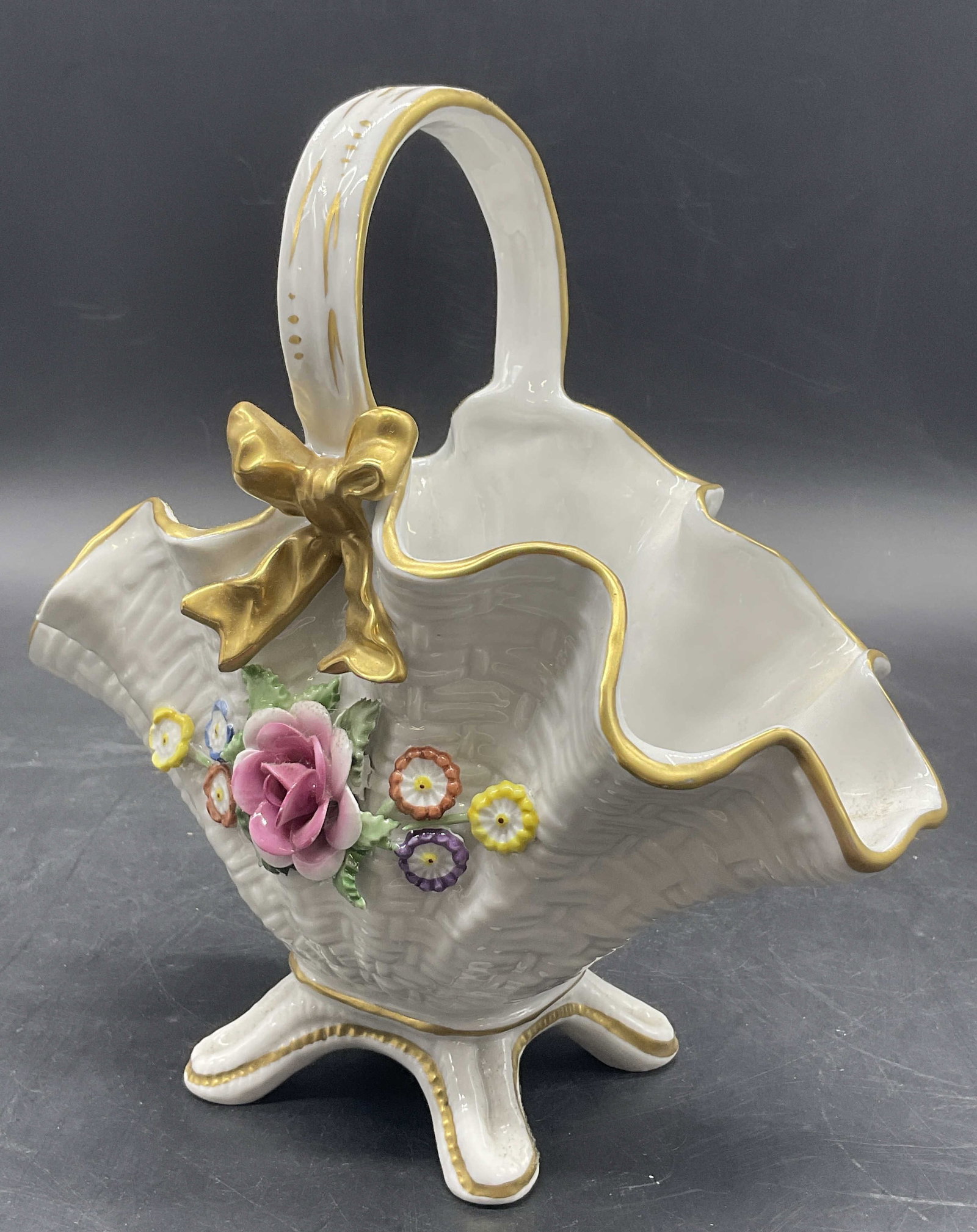 Schierholz Hand Painted Raised Floral Basket: Schierholz hand painted raised floral motif porcelain basket. Gilt line work and floral motifs throughout. Underside marked with PMP 1817, Hand painted. Measures approx. 7.25H x 7.25W in. Surface wear