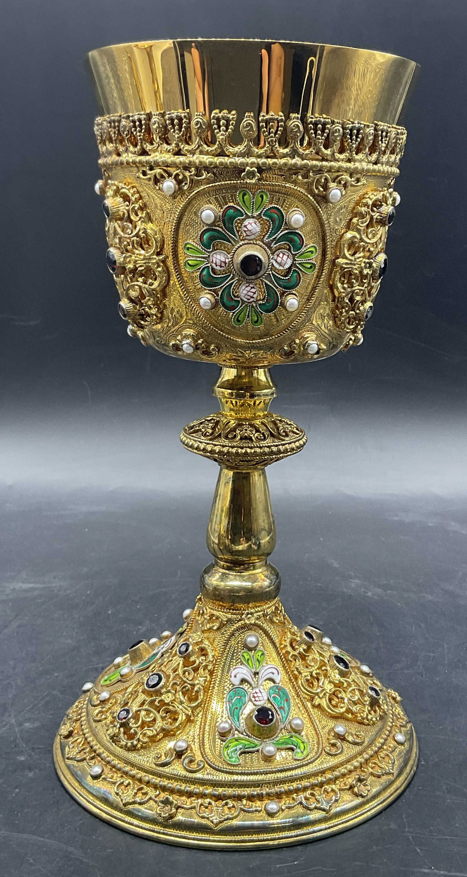 Gilt Sterling Enamel & Semiprecious Stone Chalice: Gilt Sterling Enamel & Semiprecious Stone Chalice / Ceremonial Cup. Weighty. Decorated with pearls, garnets, and enamelwork. Raised metalwork throughout the piece. Measures approx. 9.25H x 5W in. Disc