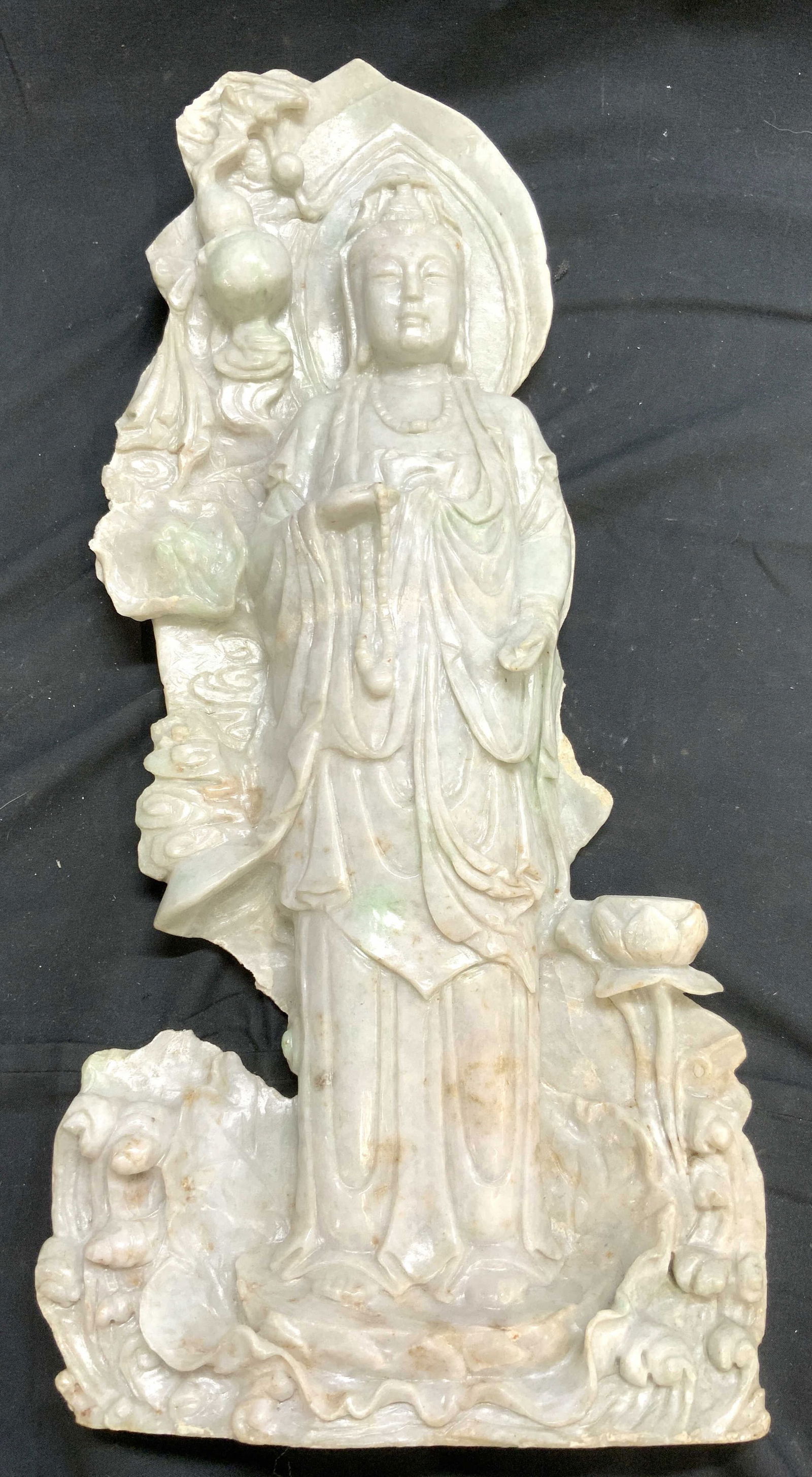 Dushan Green Vntg Asian Guan Yin Sculpture: Guan Yin sculpture is vintage. Piece depicts standing Guan figure with one hand extended towards ground. Guan Yin sculpture is jade. Piece is significantly weighted. Jade Guan Yin sculpture measures a