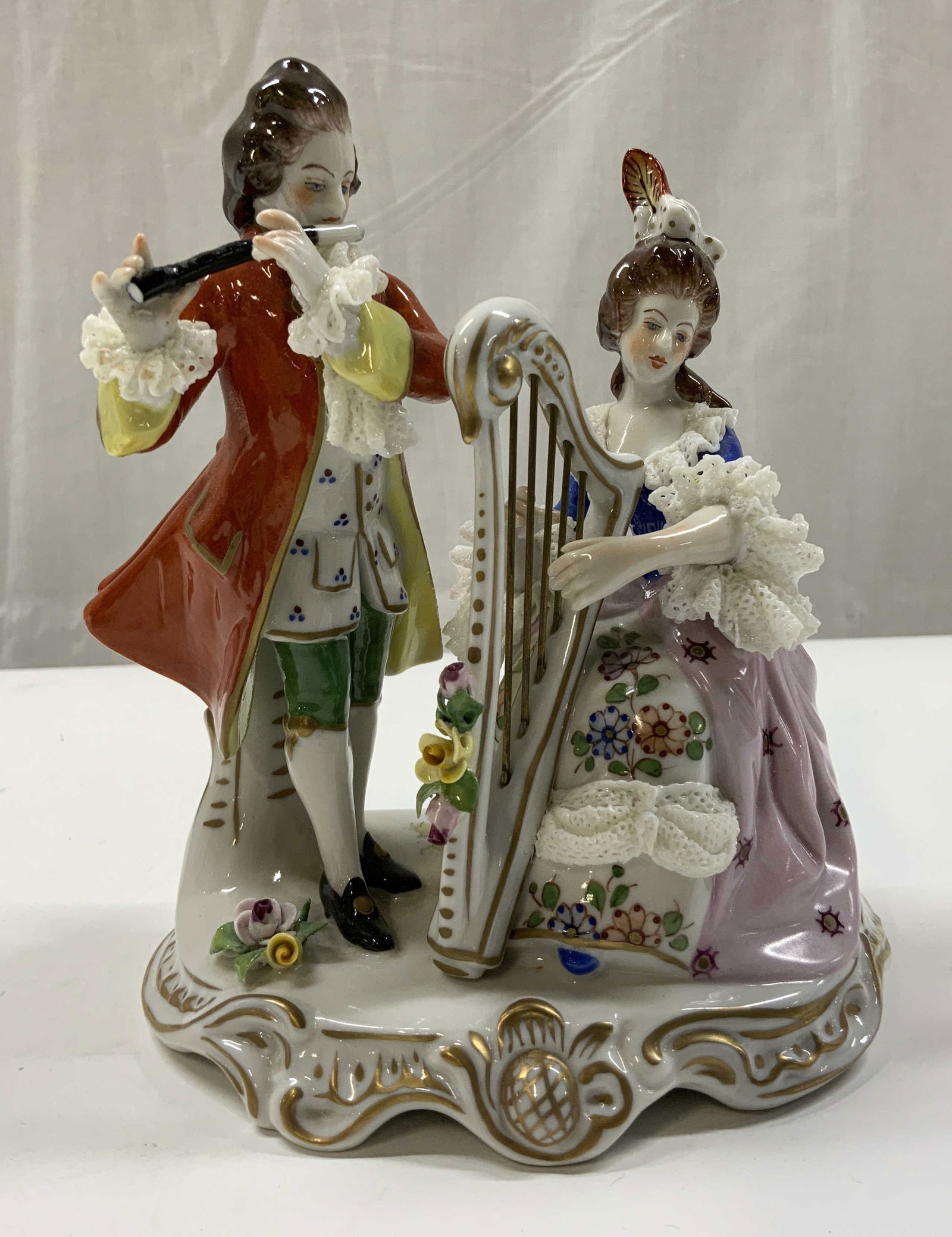 SITZENDORF DRESDEN Porc Musical Duo Figural German: Antique SITZENDORF DRESDEN Porcelain Musical Duo. Porcelain duo figural, each with musical instruments. Gentleman has flute, orange flare jacket & gold detailing lace, cuffs & bow. Female seated with
