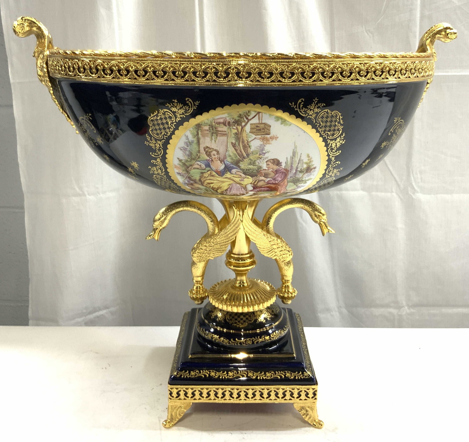 F KERAMOS 19th C French Ormolu Centerpiece: Underside of basin is marked F KERAMOS. Piece appears to be antique 19th century French. Possibly vintage. Centerpiece is porcelain. Gilt French ormolu pedestaled centerpiece. Vessel has 4 scrolled fe