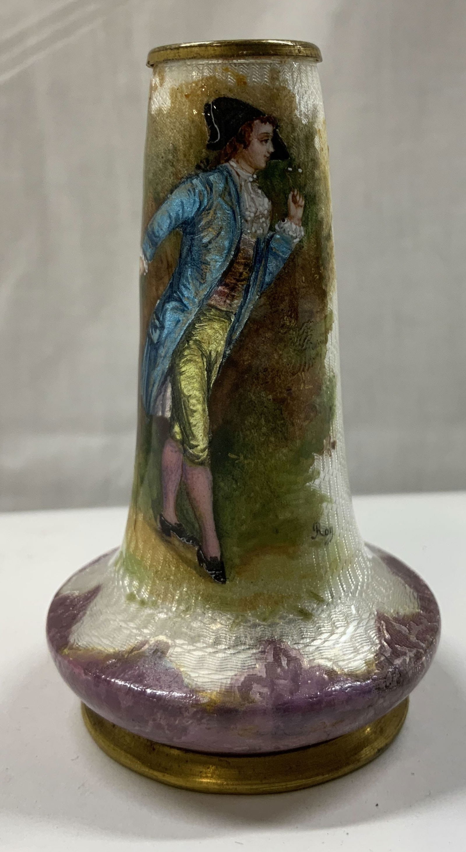 Antique French Guilloche Limoges Bud Vase: Antique French Guilloche Limoges Bud Vase Circa 19th hundreds, hand-painted French enameled gilt metal vase. Vase has detailed figural of gentleman in blue coat. Pink & yellow garments holding a c