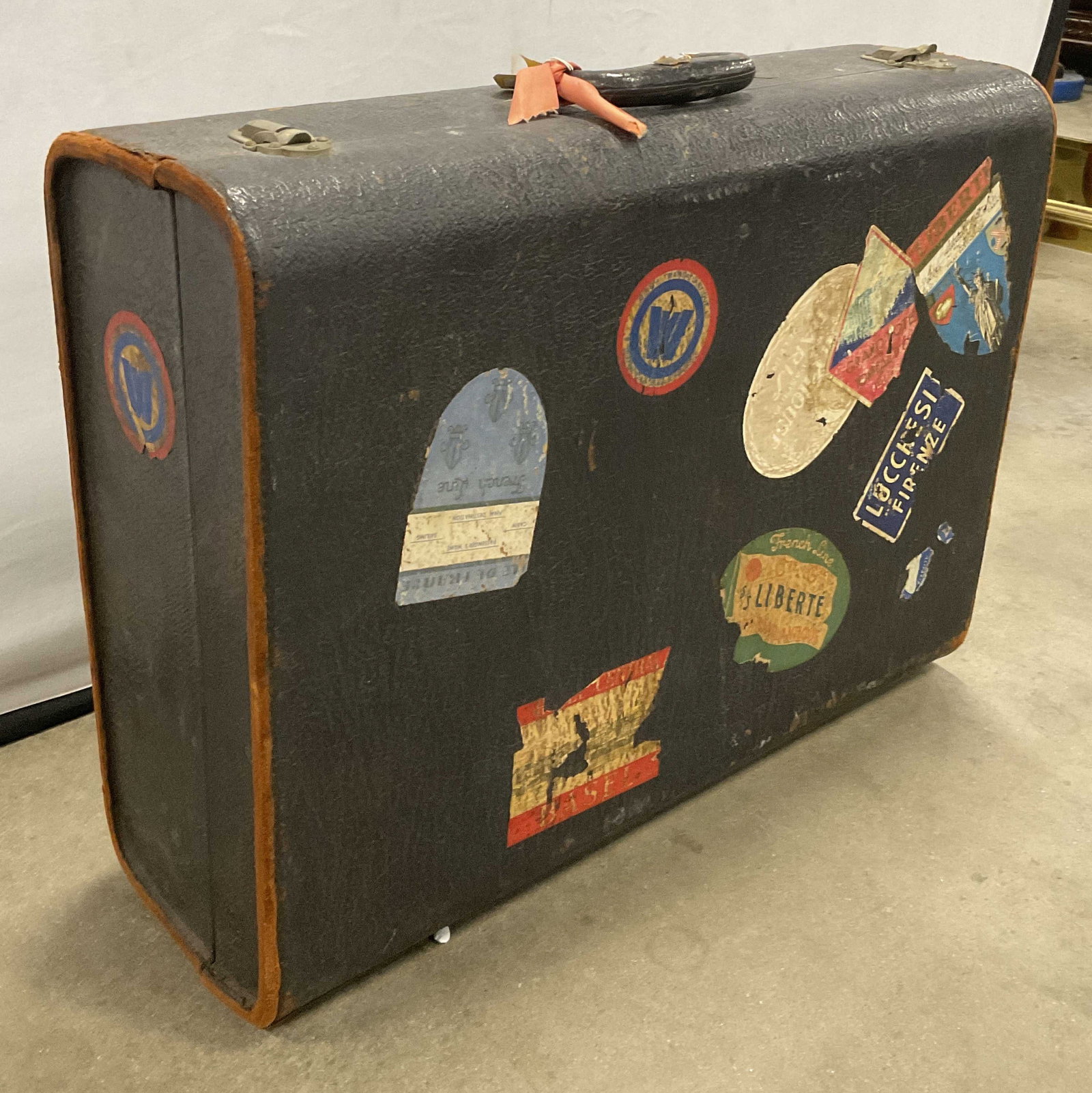 DOVER Vintage Travel Trunk W/ Travel Stickers: Vintage Travel Trunk with Vintage Travel Stickers. Initials TW to the top. Crafted from leather or leather style material, fabric, composite, and metal materials. Top handle and metal hardware to the 