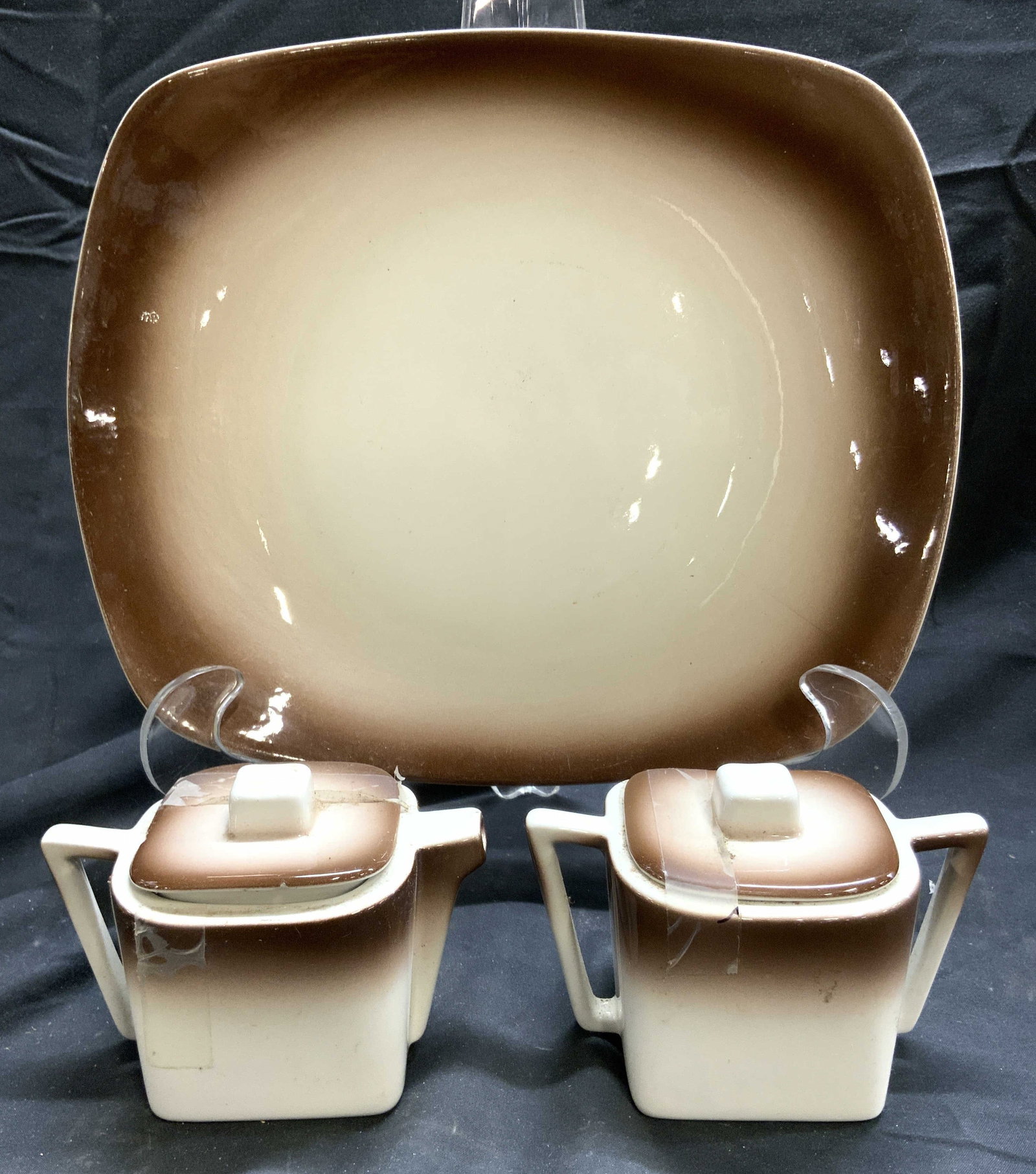 ORCHARDWARE Serv Plate Crm & Sugar Dishes, Lids US: Undersides are marked ORCHARDWARE Americana Made in USA. Lot includes 1 plate, & 1 sugar dish, & 1 creamer dish with lids and handles. Each piece has white to brown gradients. Plate measures approxima