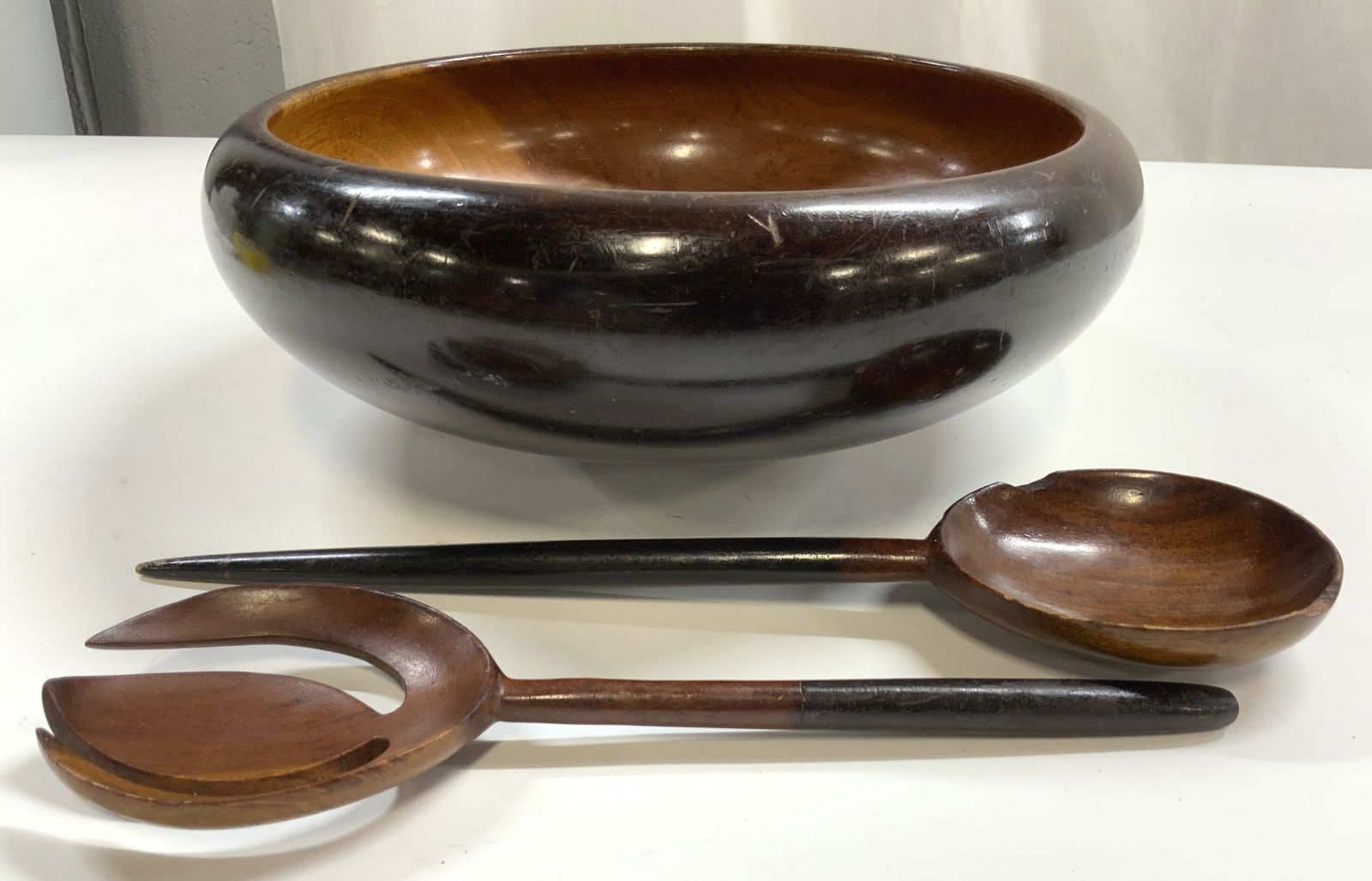 Lot 3 Teakwood Bowl & Salad Serving Utensils: Lot includes 1 bowl, 1 salad serving spoon, & 1 salad serving fork. Each piece is brown toned and wooden. Possibly teakwood. Bowl measures approximately 11.5 inches wide 4.25 inches tall. Salad servin