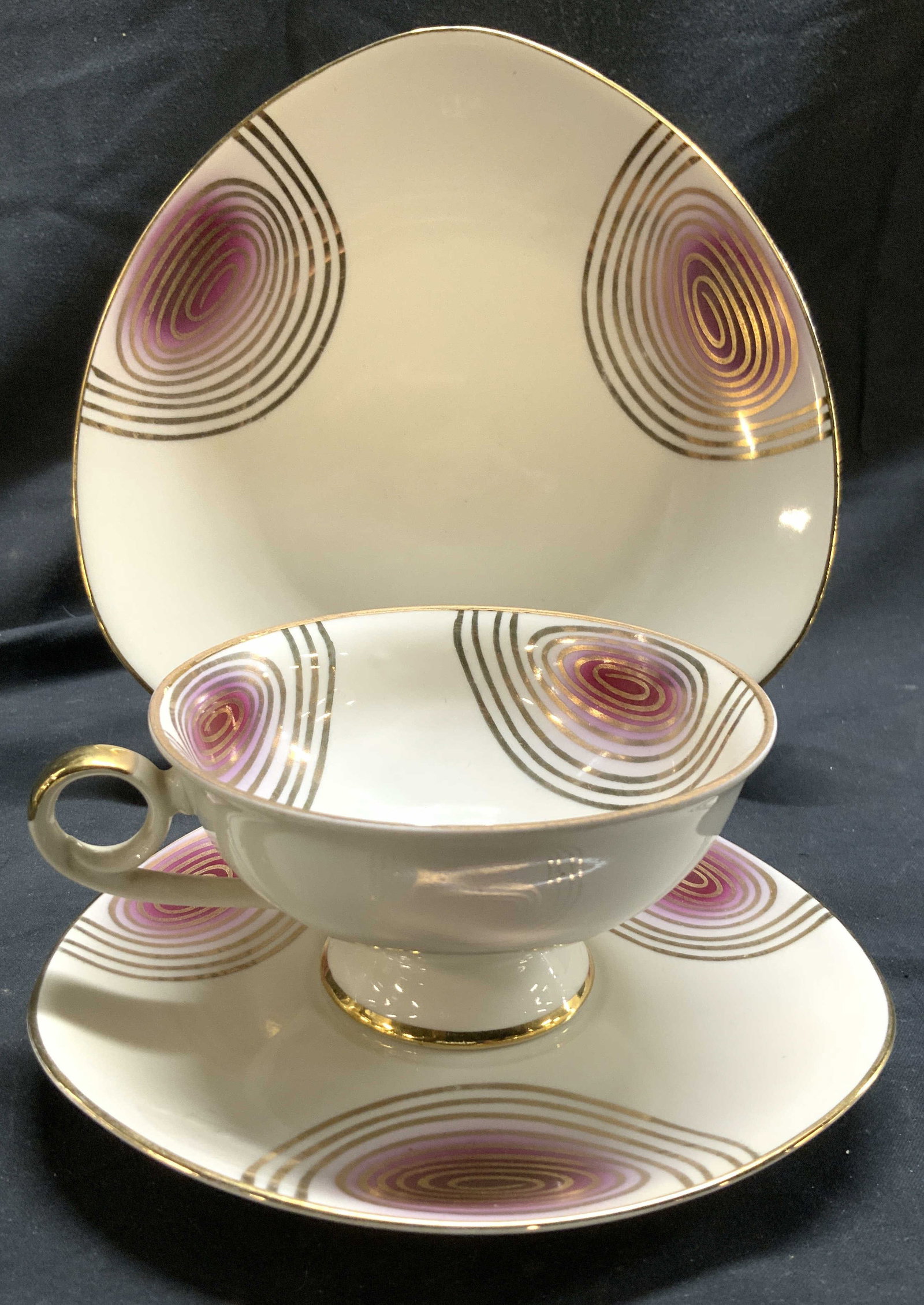 D&RW BAVARIA Set 3 Teacup Plate & Saucer: Undersides are marked D&RW BAVARIA. Lot includes 2 teacup, 1 saucer, & 1 plate. Each piece is cream with magenta & gilt spiral detailing. Each piece has gilt rims. Plate measures approximately 7.5 inc