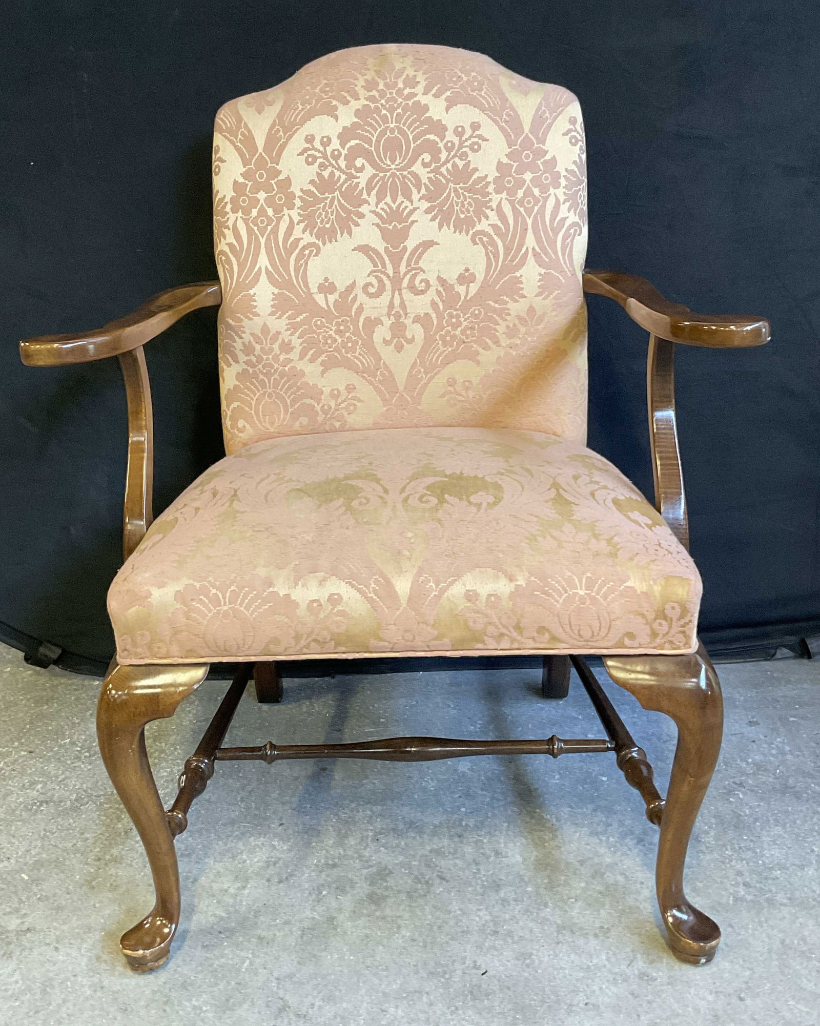 Vintage Queen Anne Style Pink Upholstery Armchair: Vintage Queen Anne Style Pink Upholstery Armchair. Semi gloss finish to the wooden frame. H form stretcher to the legs. Pink and light yellow hued soft hand upholstery to the seat and back. Measures a