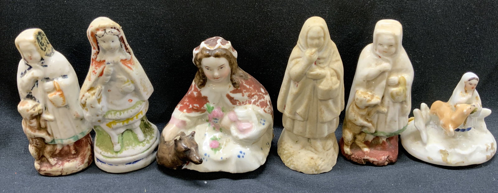 Group Lot Antique Little Red Riding Hood Figurals: Group Lot Antique Little Red Riding Hood Figurals 6 porcelain figural, they all have different features & sizes. All figural are holding a white or yellow basket. Including either a tan or brown wolf 