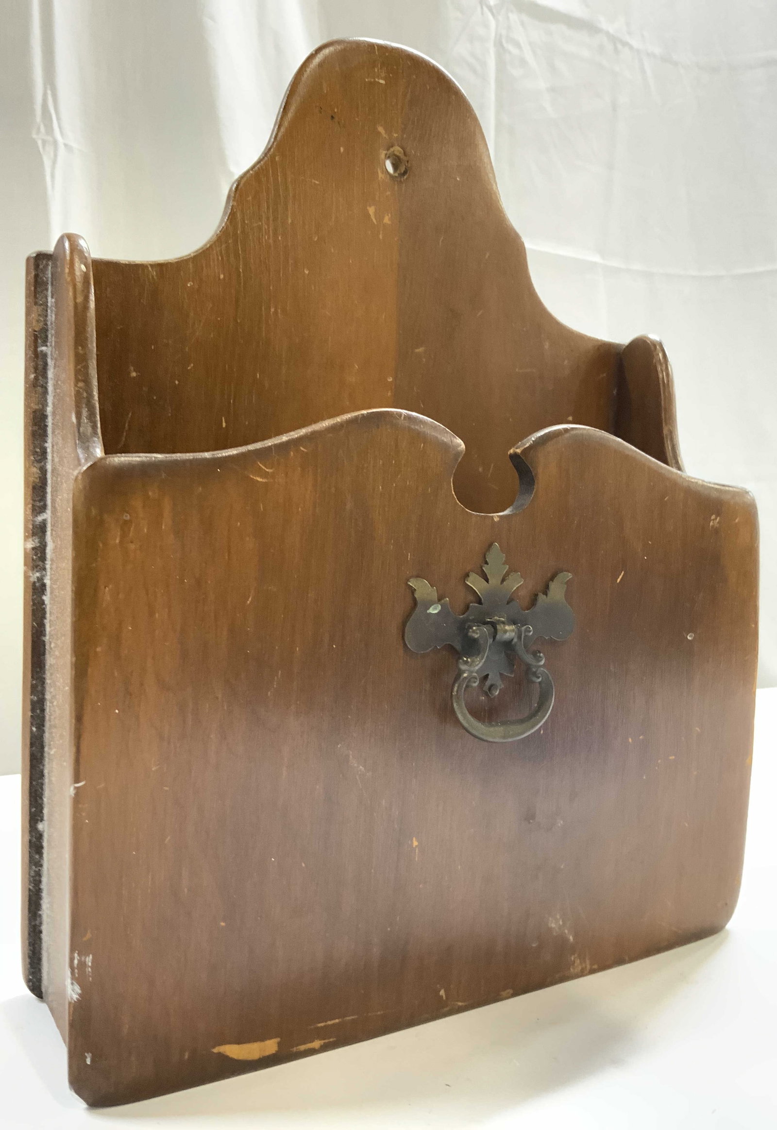 Vintage Wooden Wall File Holder: File holder is vintage. Piece is light brown toned and wooden. File holder has gilt metal handle. Piece has hole on backside to hand on wall. Piece measures approximately 12.25 inches tall 9.5 inches 